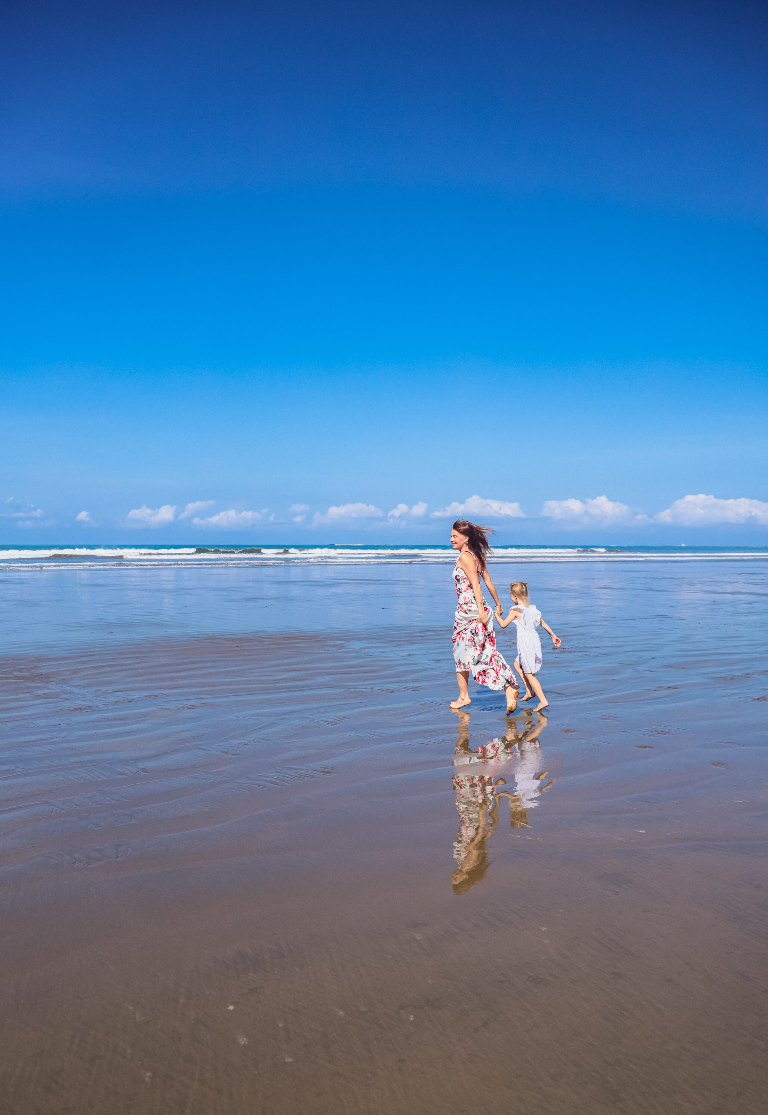 Run together along the water's edge, catch the splashes of the ocean, holding hands with mom - your children will remember these moments together, not the toys they bought.