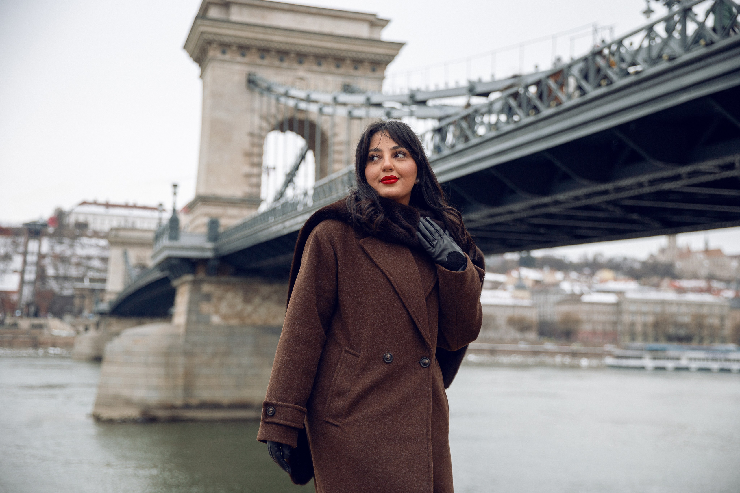A girl in the background of the Chain Bridge in Budapest