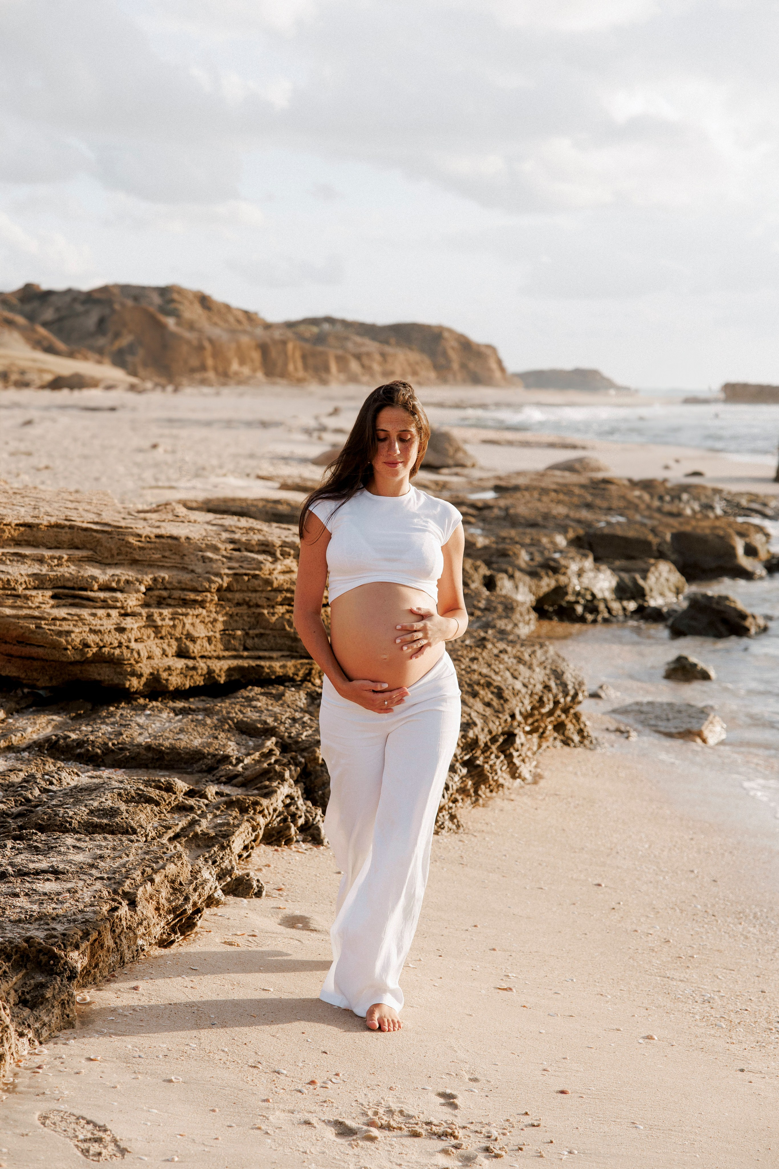 Pregnancy photoshoot near the sea. Wedding and family photographer