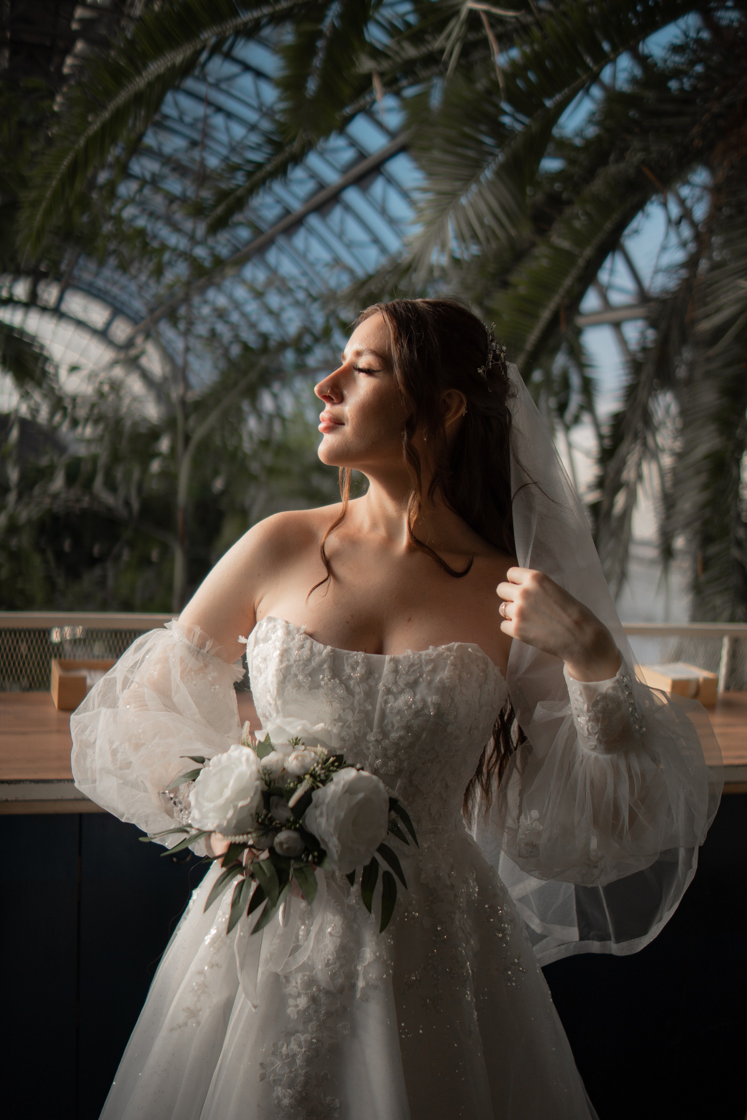 Свадебная фотография в Оранжерее Таврического сада Санкт-Петербурге. Портрет невесты, освещенной солнцем.