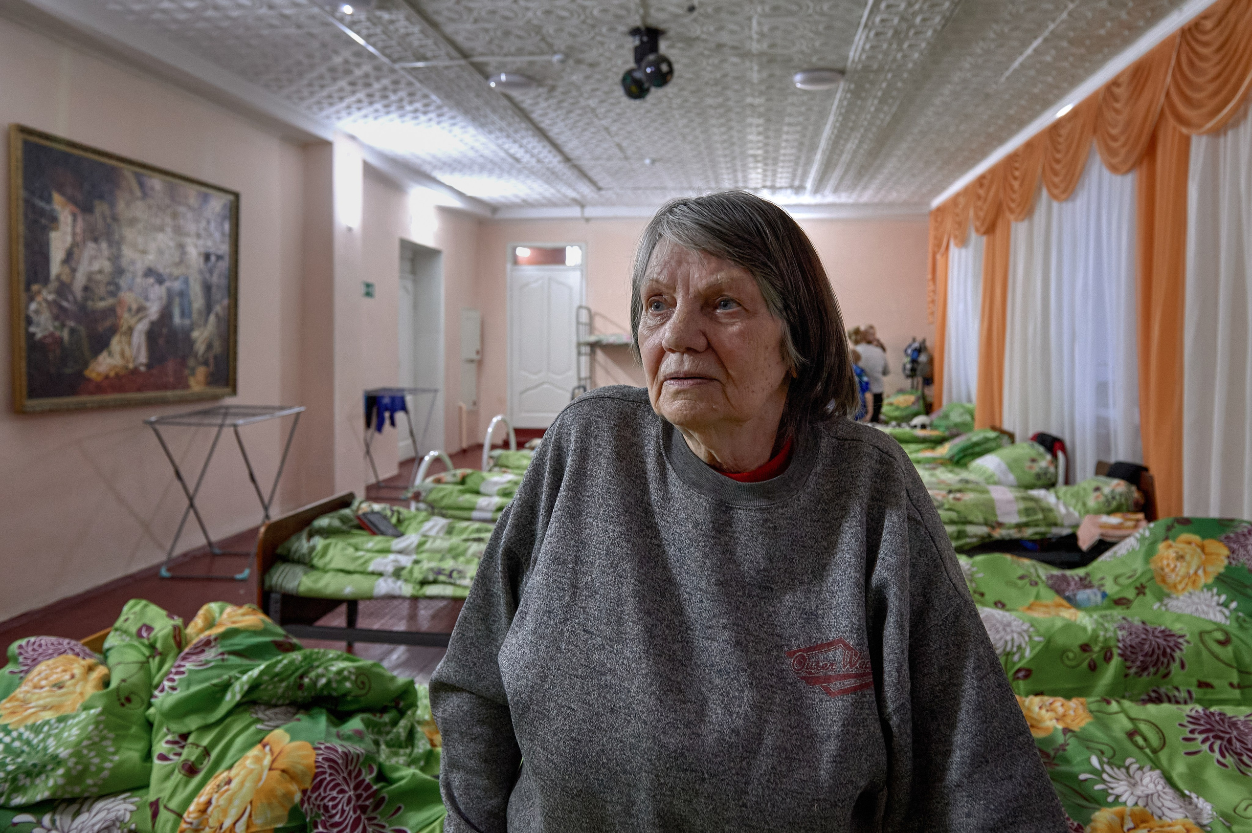 Yelena Kirillovna, evacuated from the city of Antratsyt in the Luhansk region, is seen in a temporary refugee accommodation center set up in a cultural center in the village of Krasnogornyatsky, February 26, 2022.