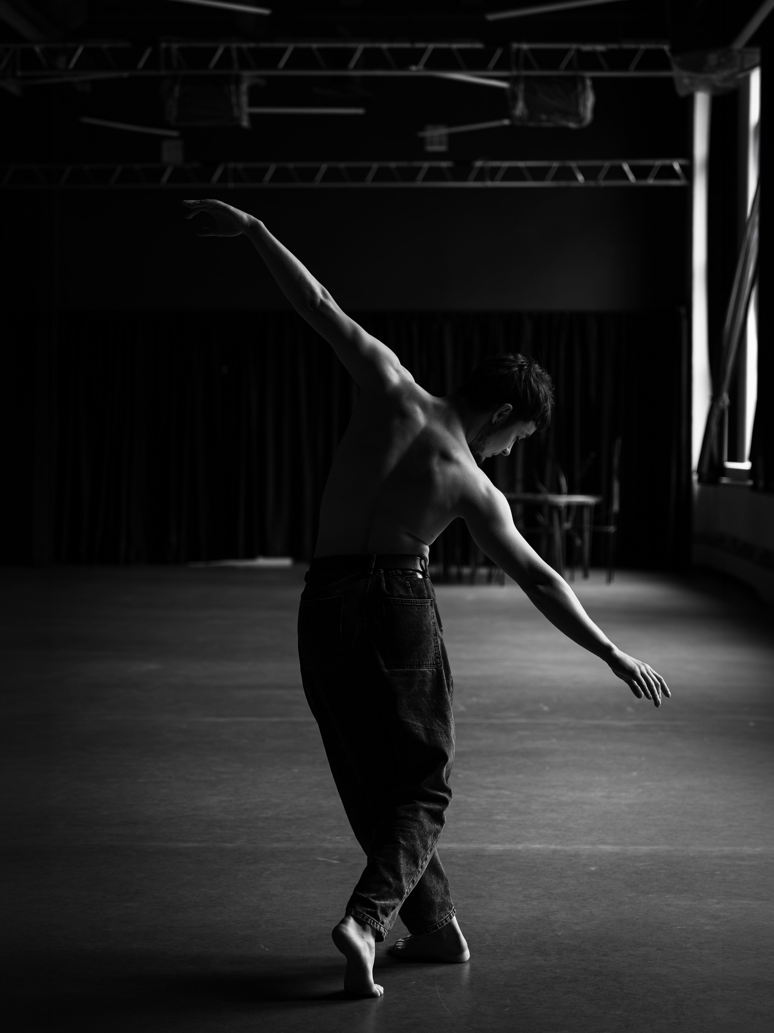 Танцовщик на полупальцах, рука поднята вверх, пустой зал — съёмка в зале Smart Dance