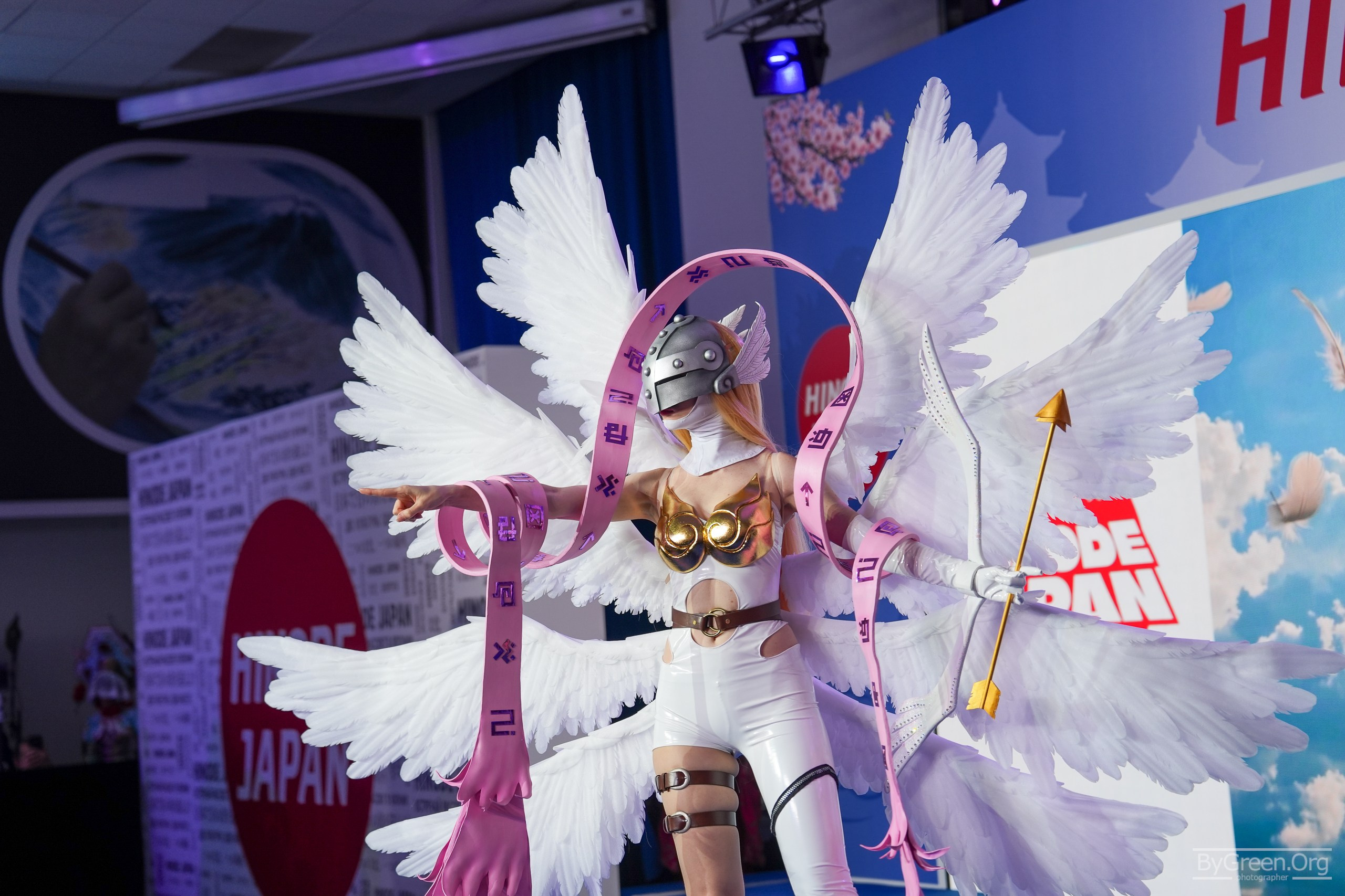 Cosplay of Angewomon from Digimon — eight white wings and a bow, Hinode 2026, Moscow
