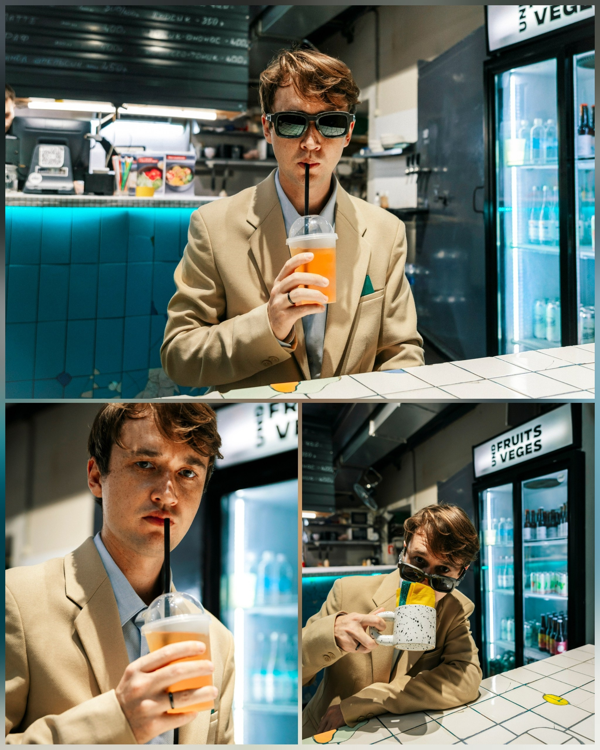 парень в очках сидит в бистро и пьет смузи