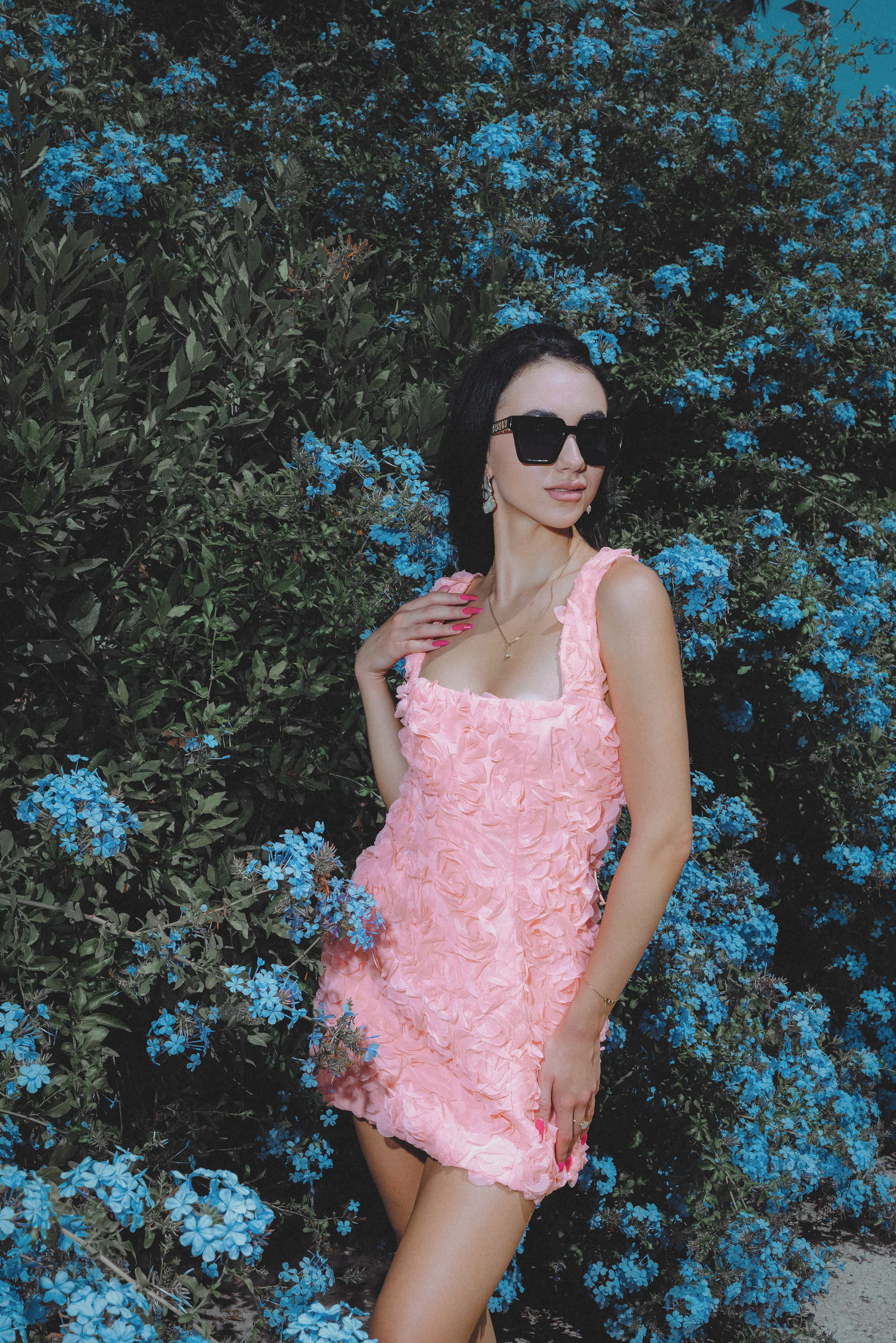Woman in a romantic pink dress exploring the Gothic Quarter in Barcelona.