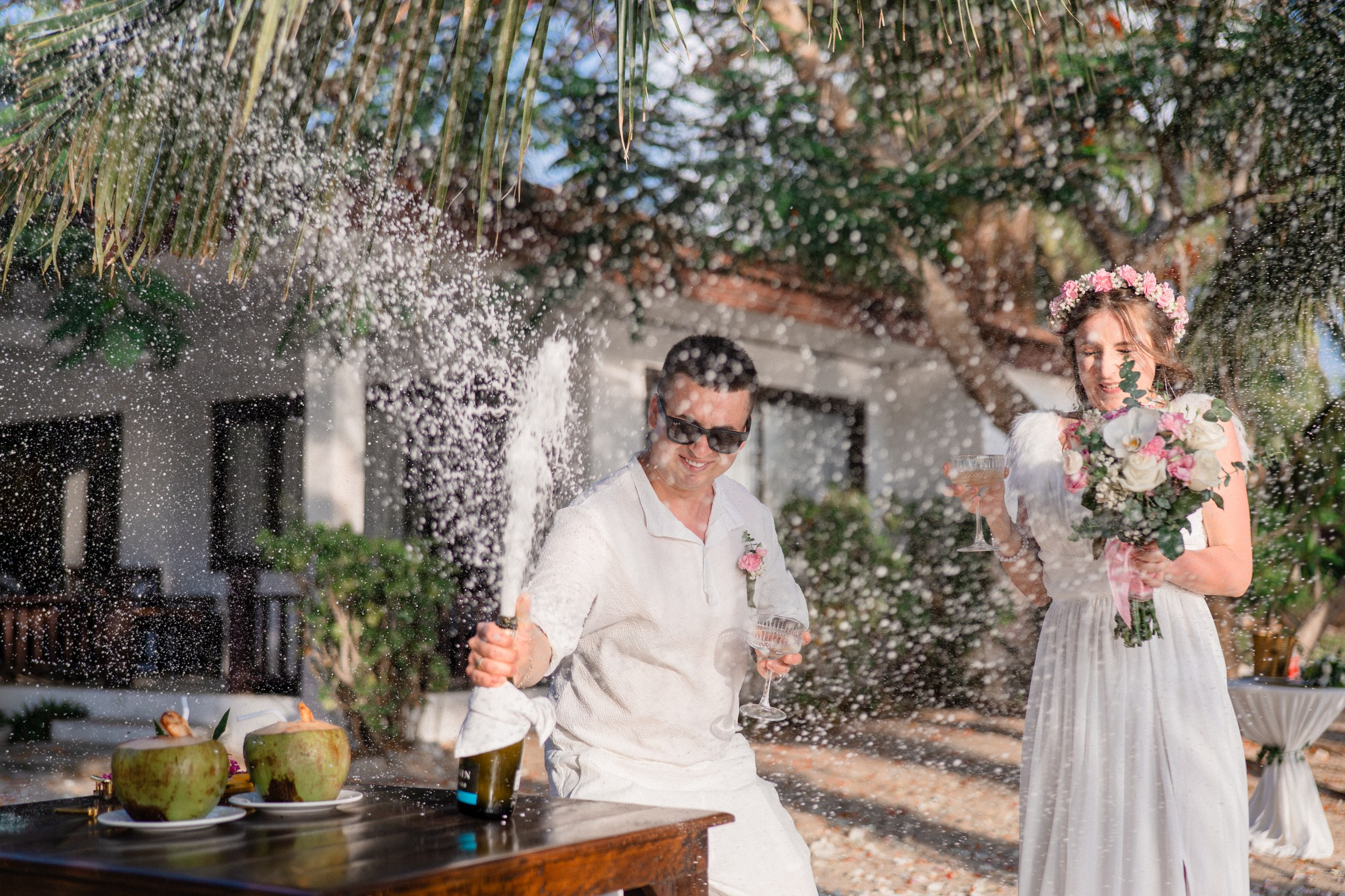 Bride and groom during a romantic beach wedding ceremony on Koh Samui, Thailand, surrounded by tropical scenery and ocean views