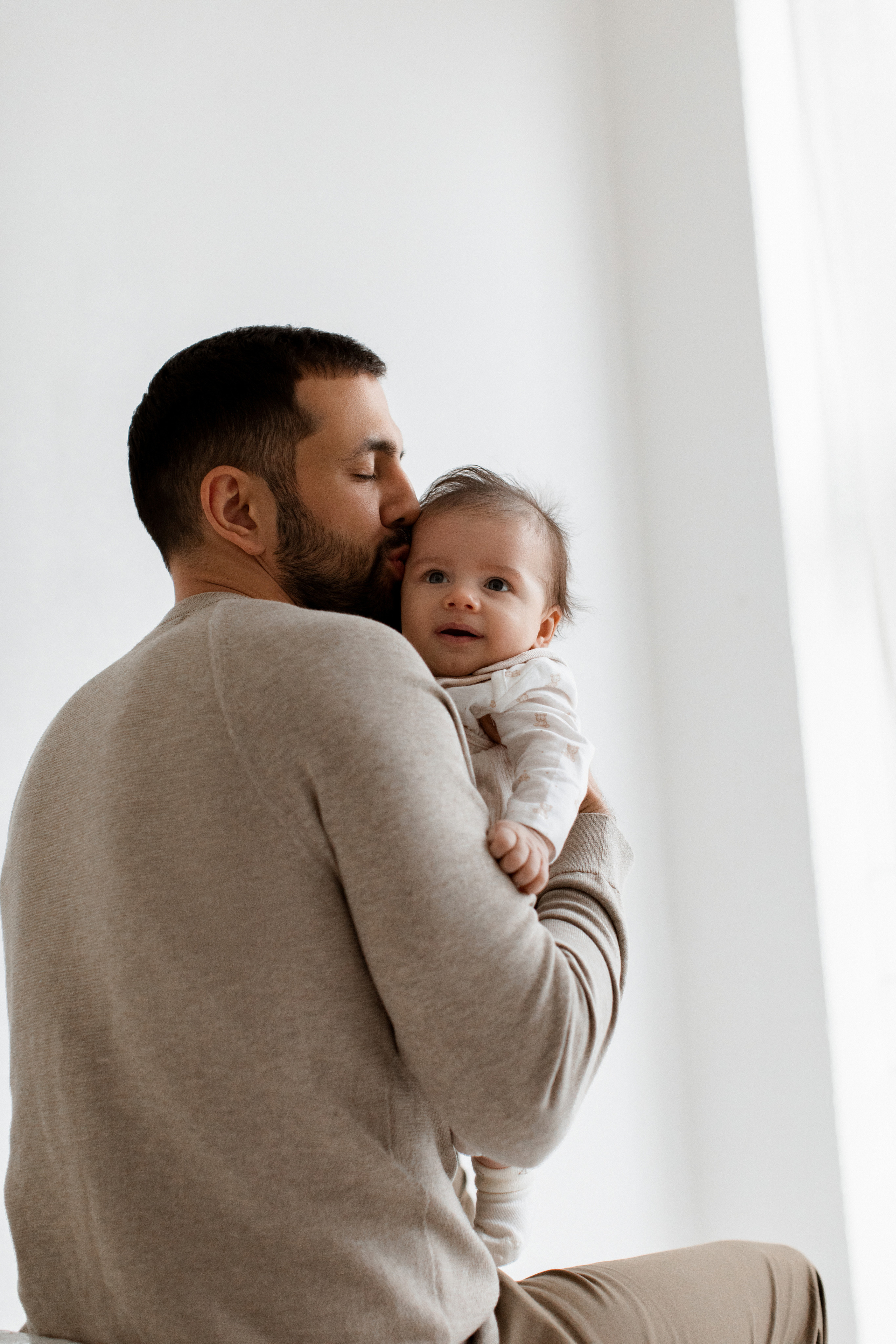 Папа целует своего ребенка сына