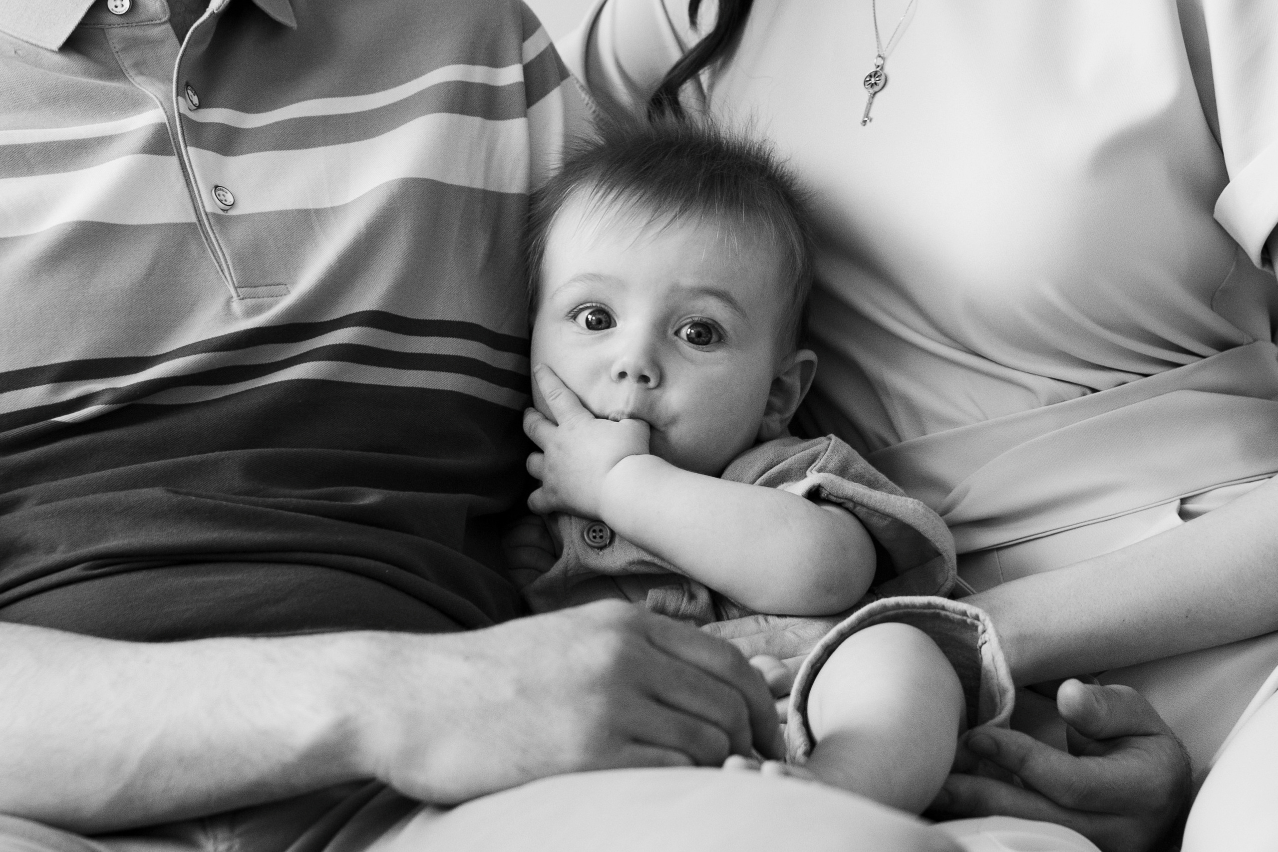 Ребенок на руках у родителей черно-белое фото