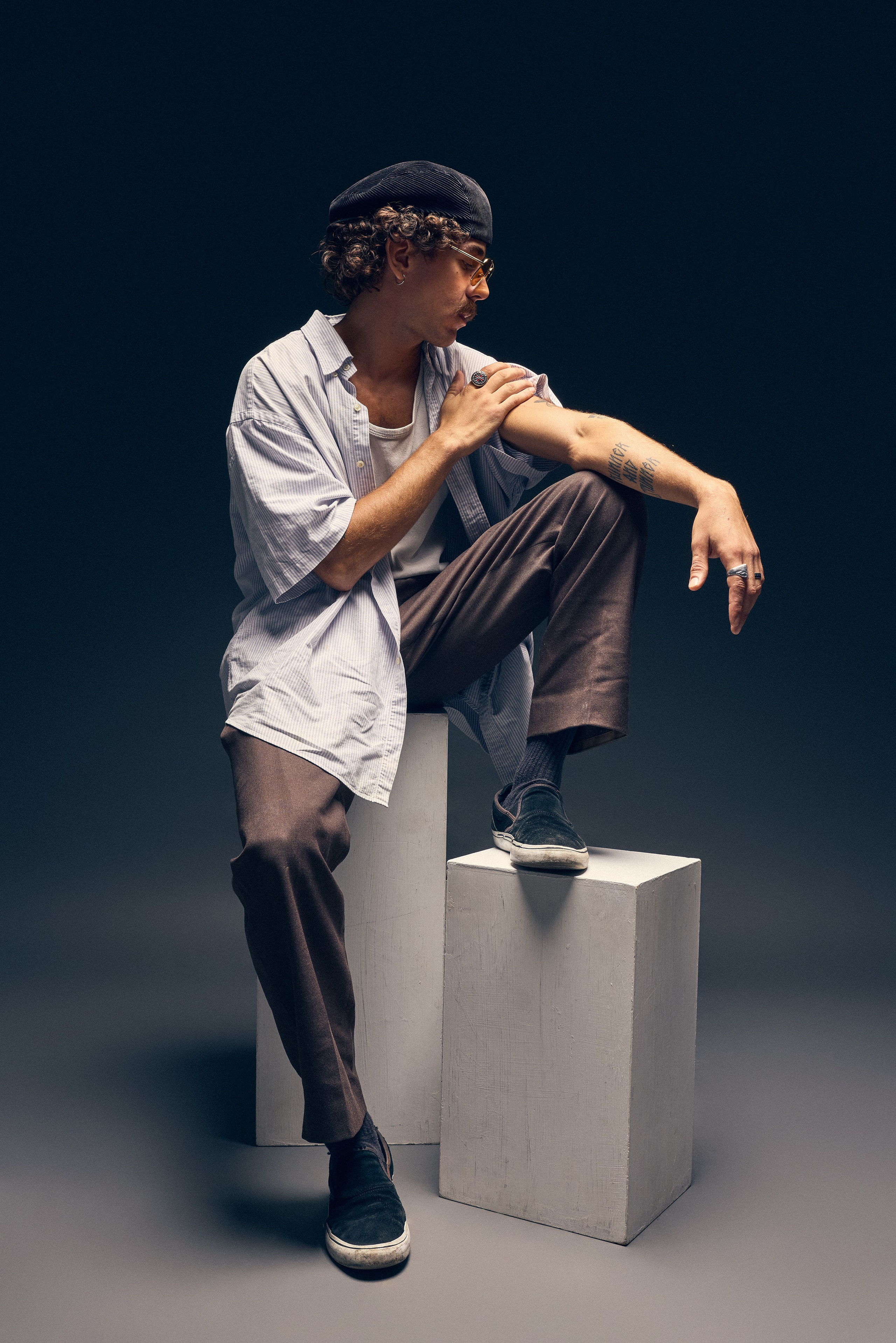 Man with jewelry and open shirt in artistic portrait