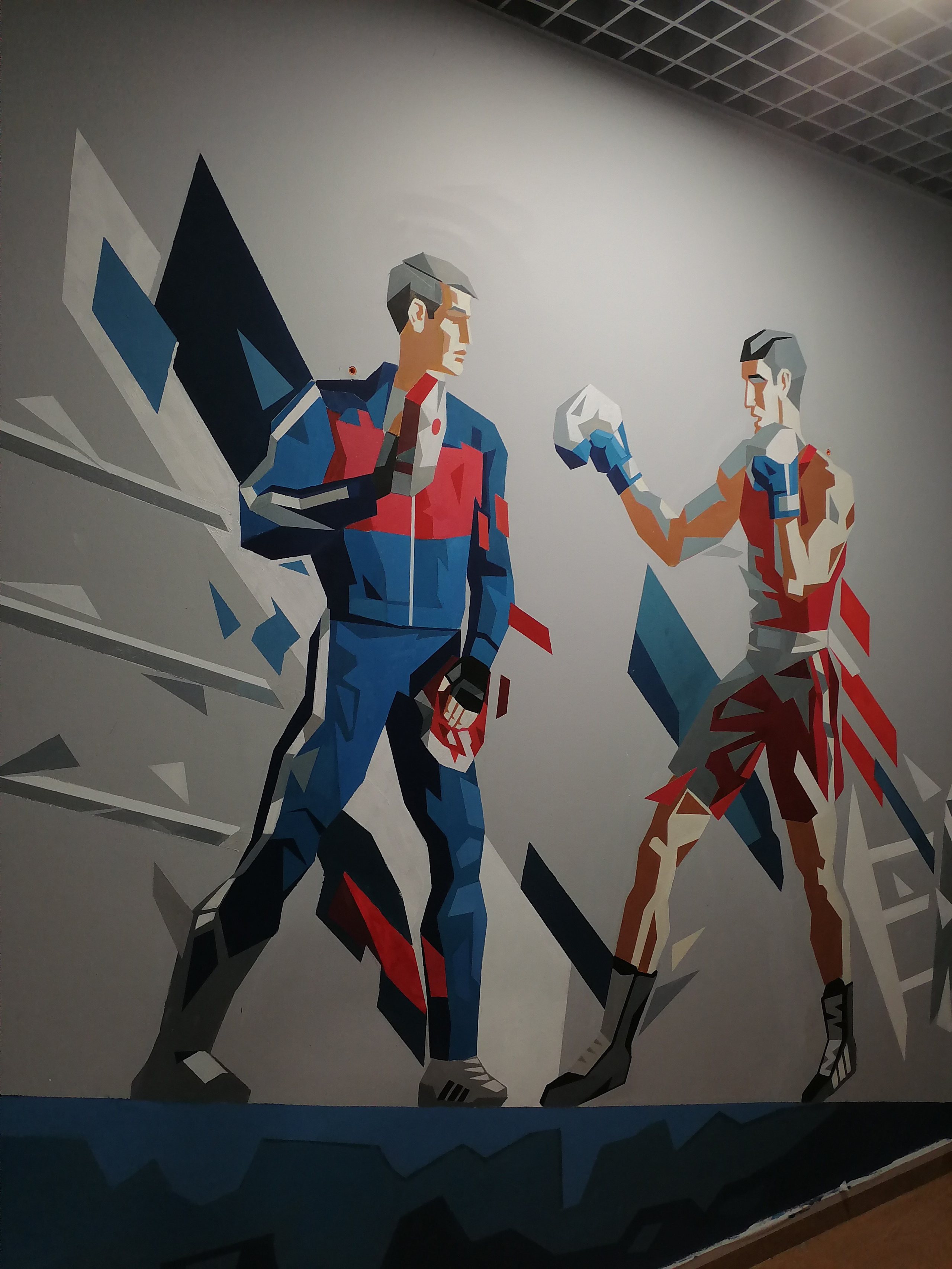 Изображён ринг на нём стоят тренер и боксёр.