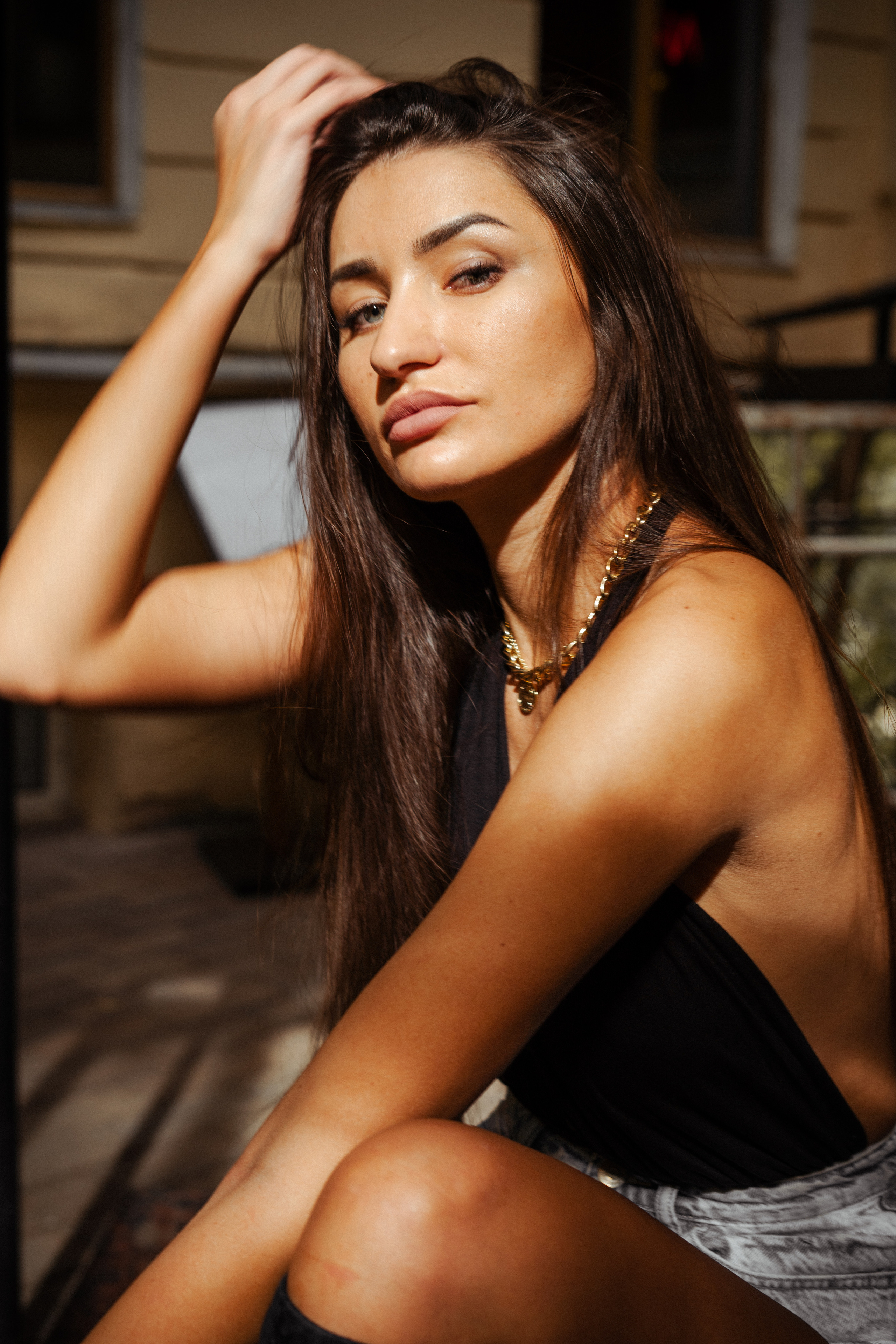 a dark-haired beauty posing against the backdrop of Moscow architecture