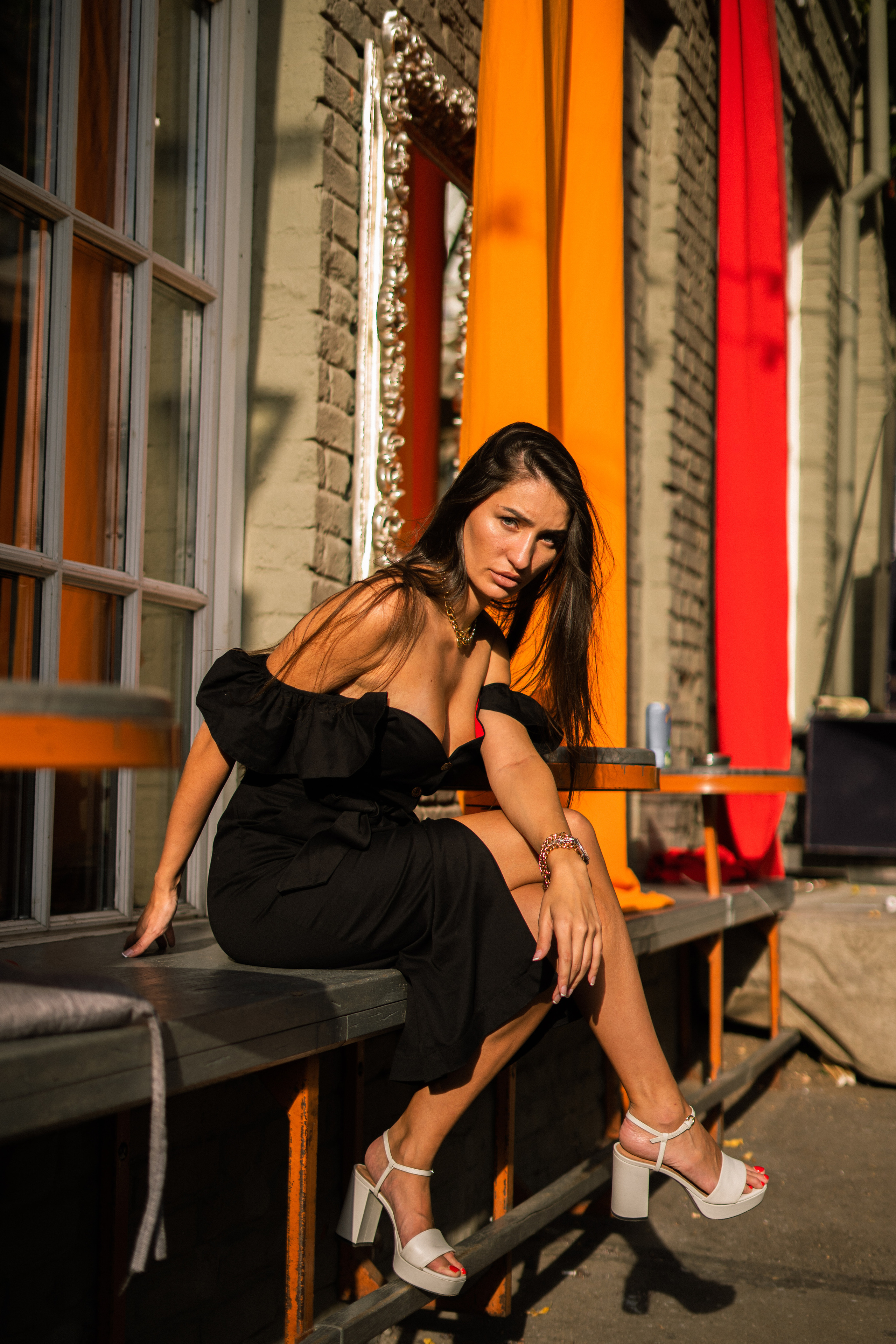 beautiful girl in a black dress in a Moscow courtyard