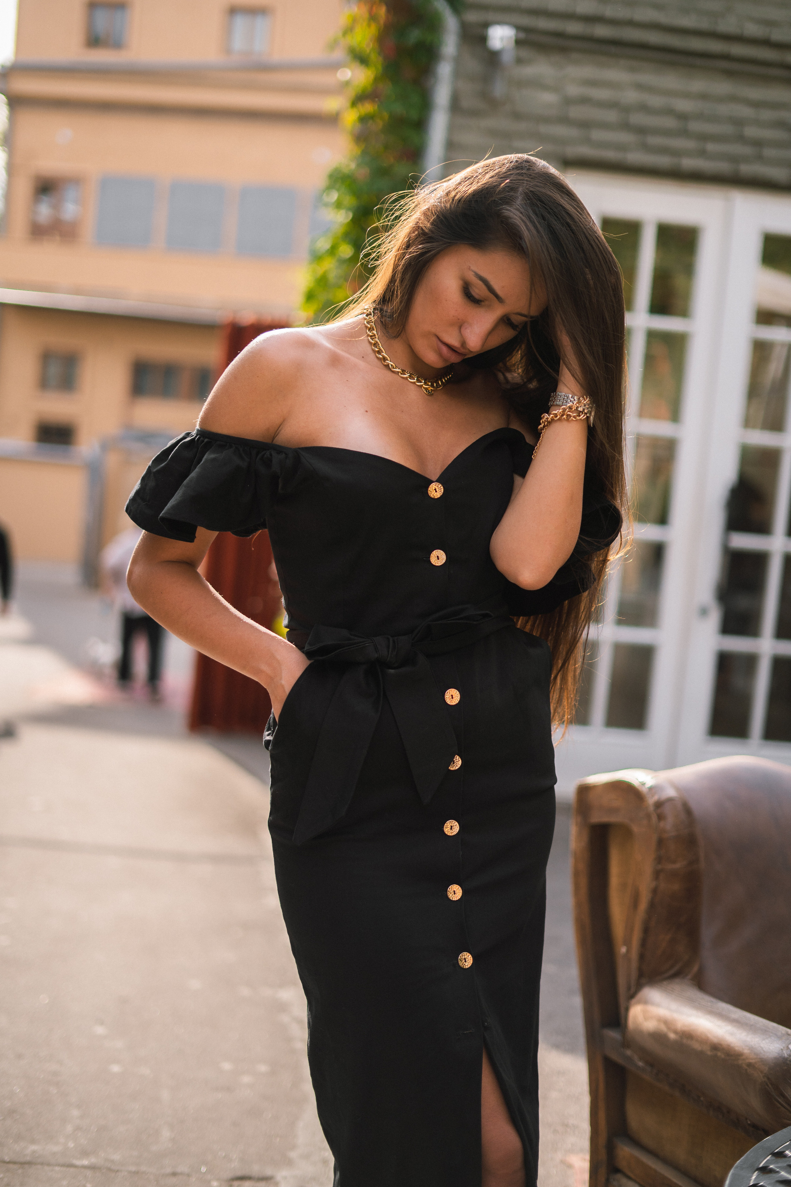 a girl in a black dress enjoying the moment in a Moscow courtyard