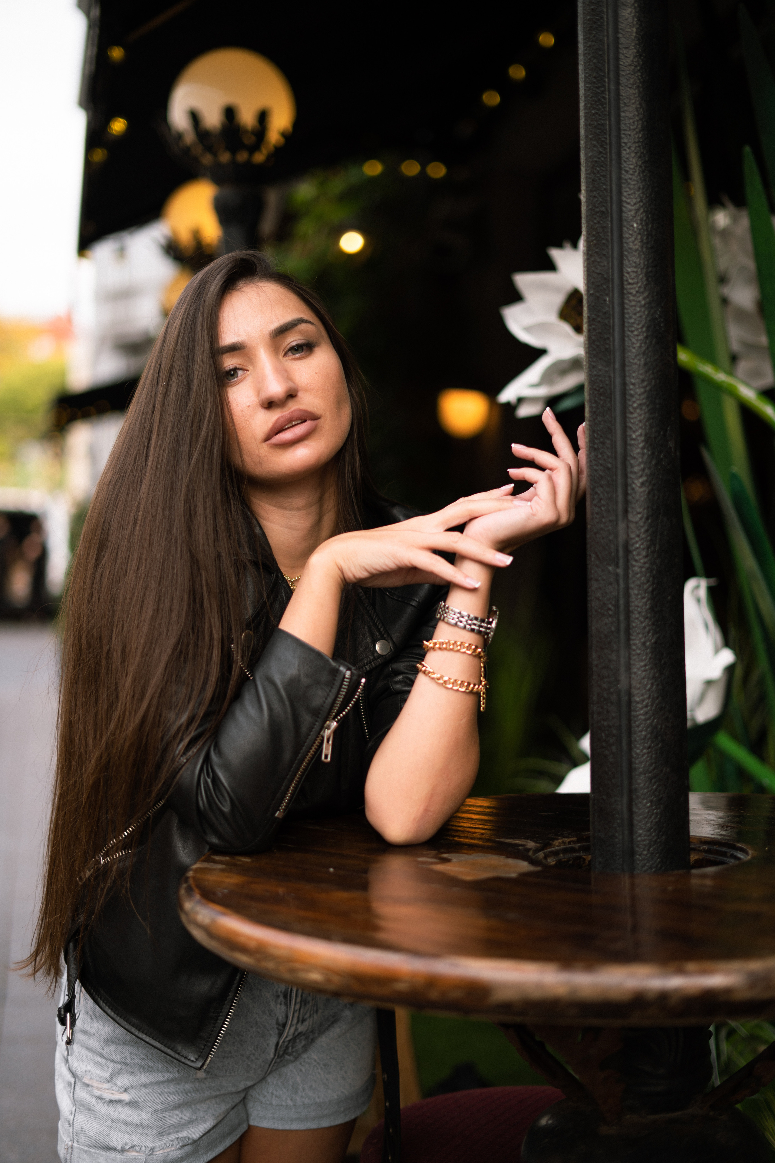 a girl with dark hair walking along a street with cozy cafes in Moscow