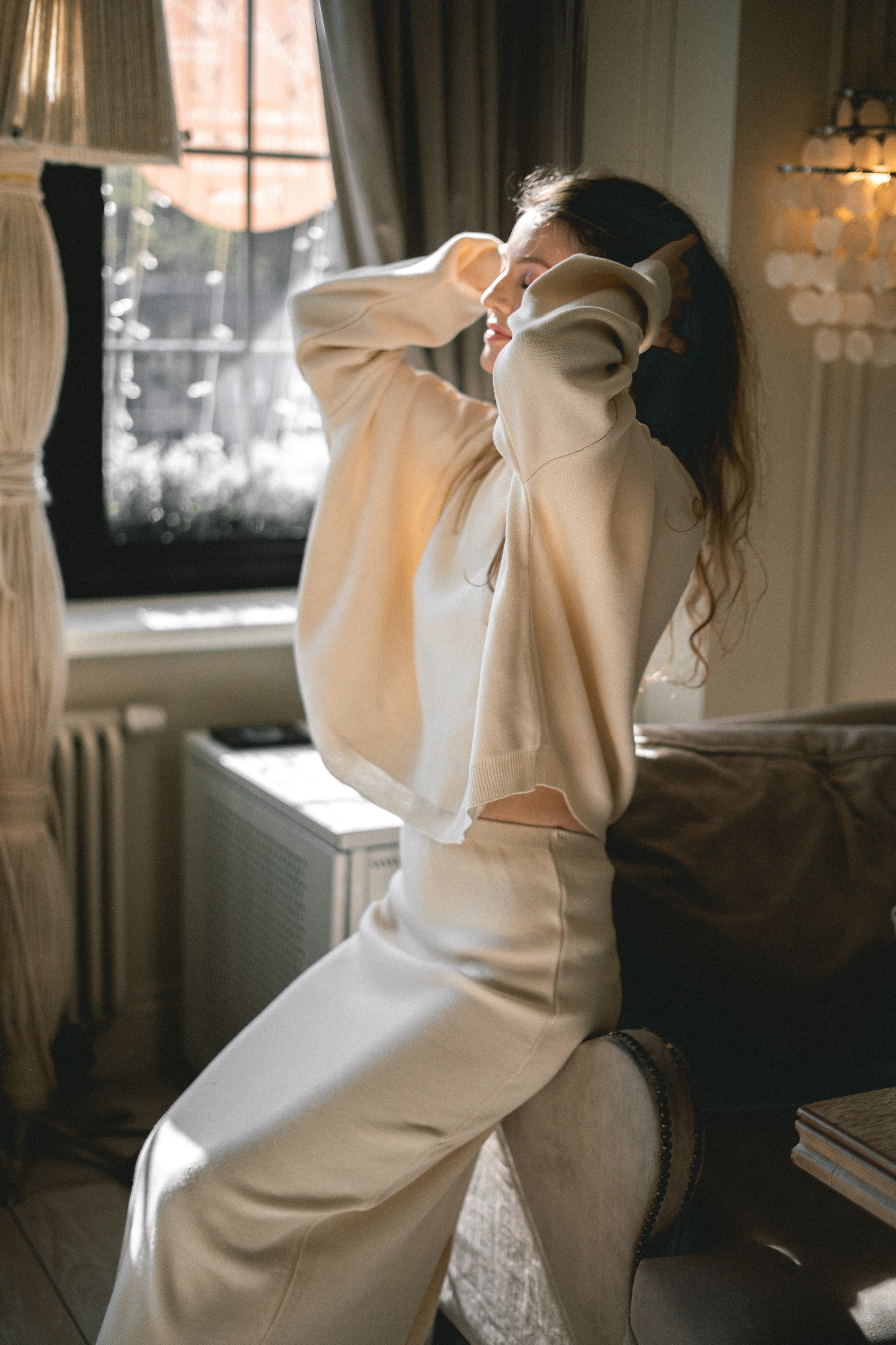 photoshoot of a girl in a white outfit in a cozy café