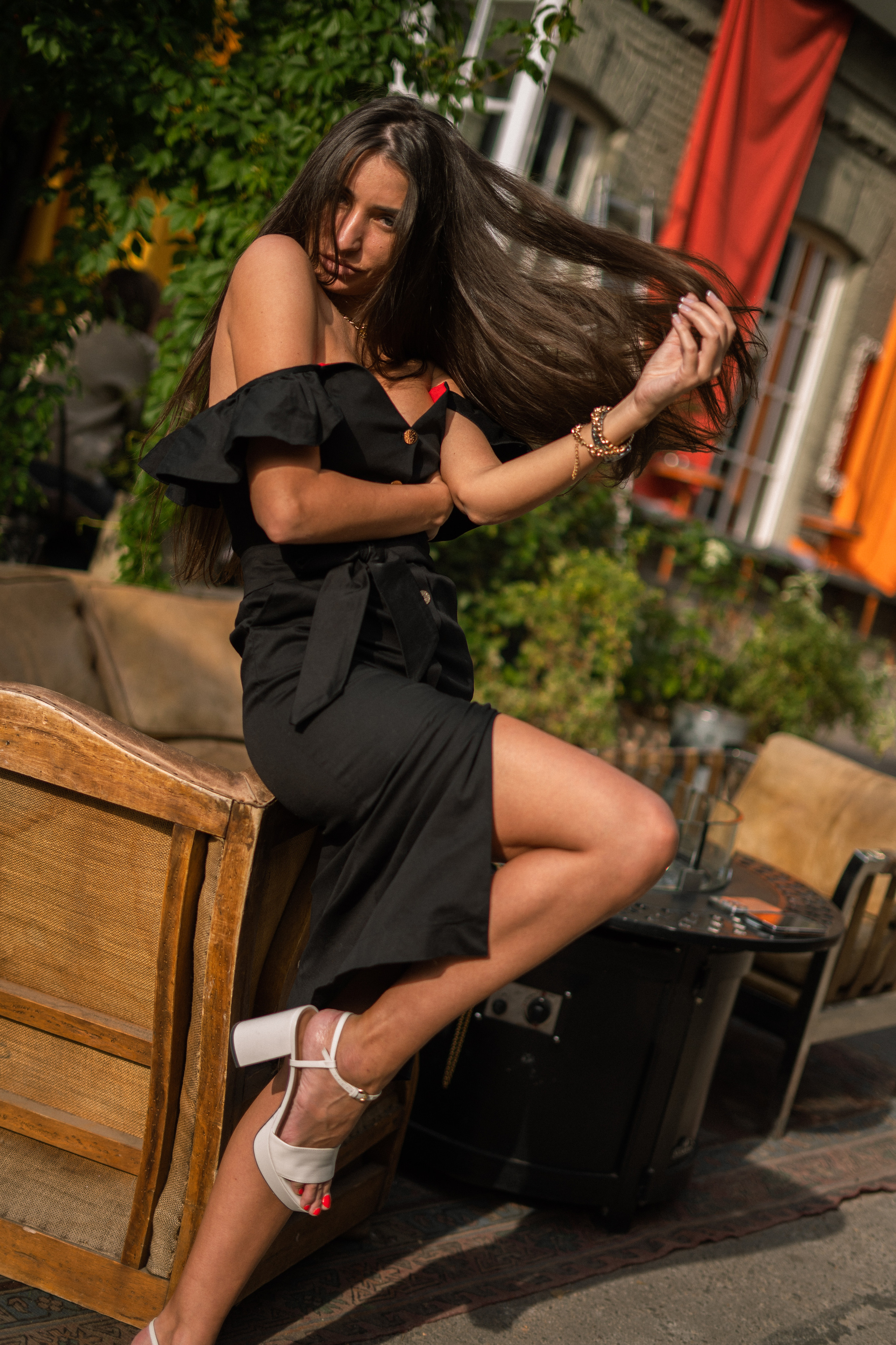 a girl in a black dress with short sleeves against a cozy atmosphere