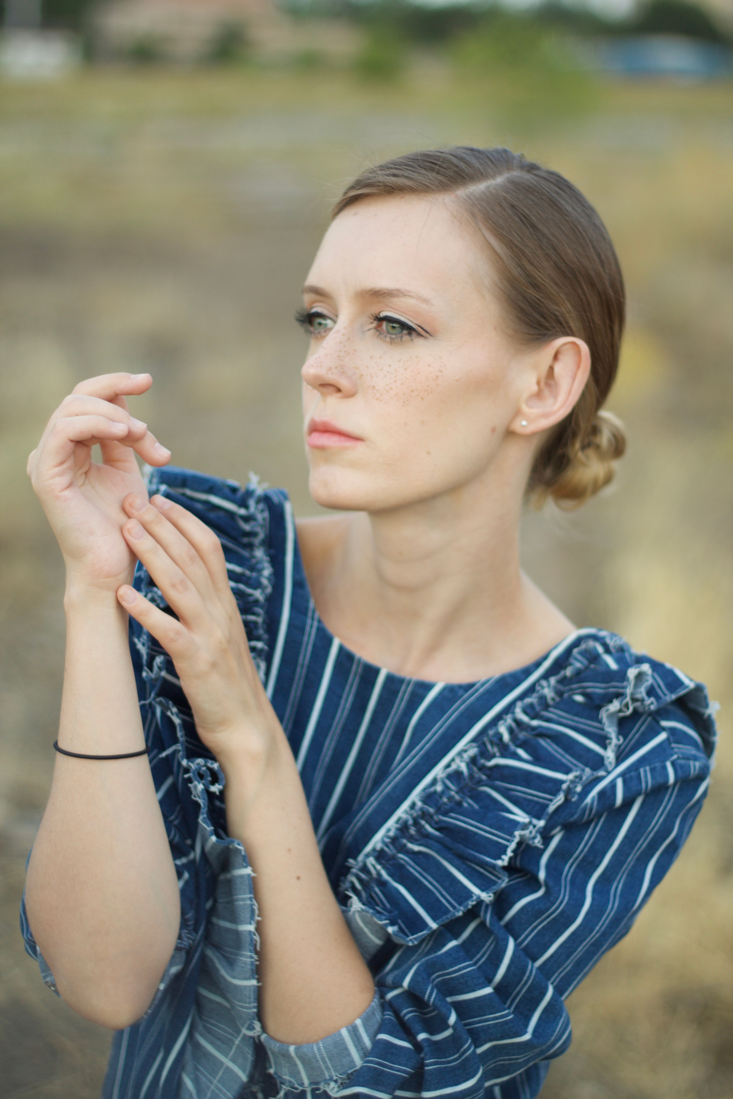 Portrait of woman who catch her hands behind