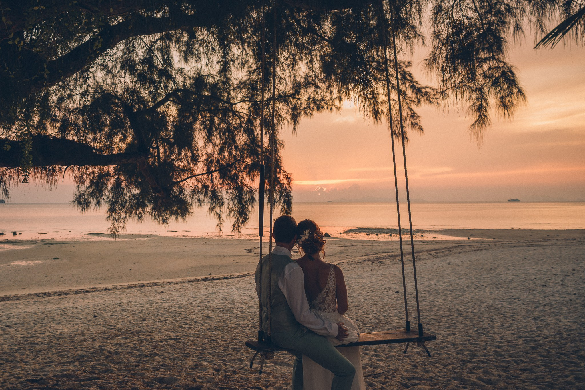 Wedding celebration with guests on a tropical sunset beach in Koh Samui