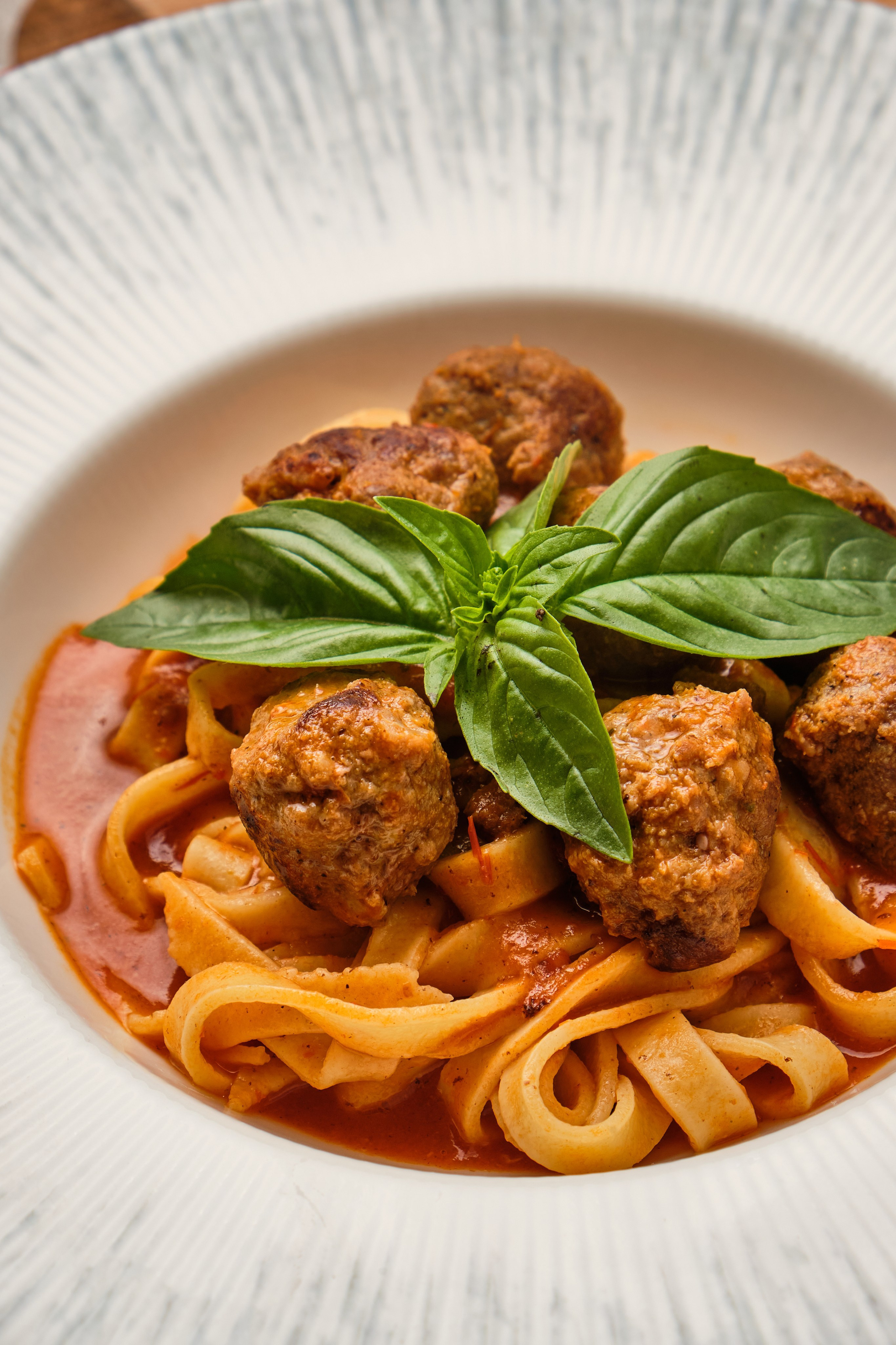 Food photography of pasta with meatballs for restaurant menu and website