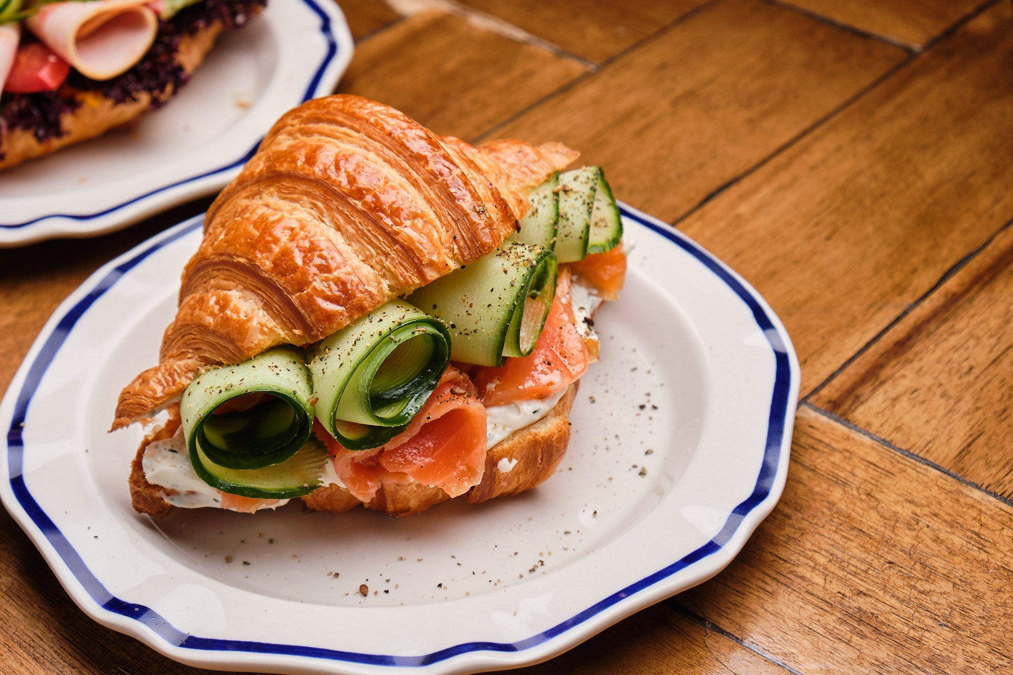 Gourmet salmon croissant dish photo for restaurant menu and social media in Tbilisi