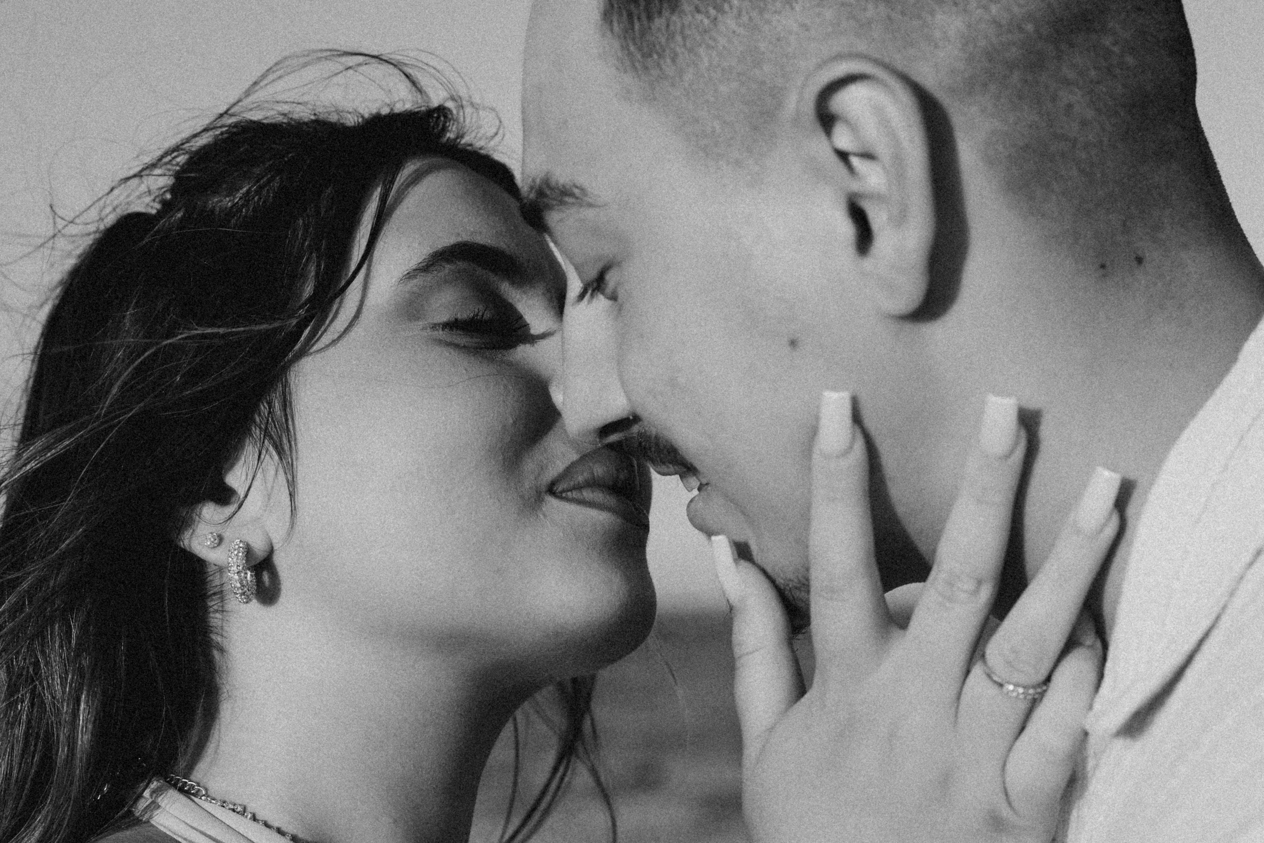 Urban proposal at sunset with city skyline behind the couple