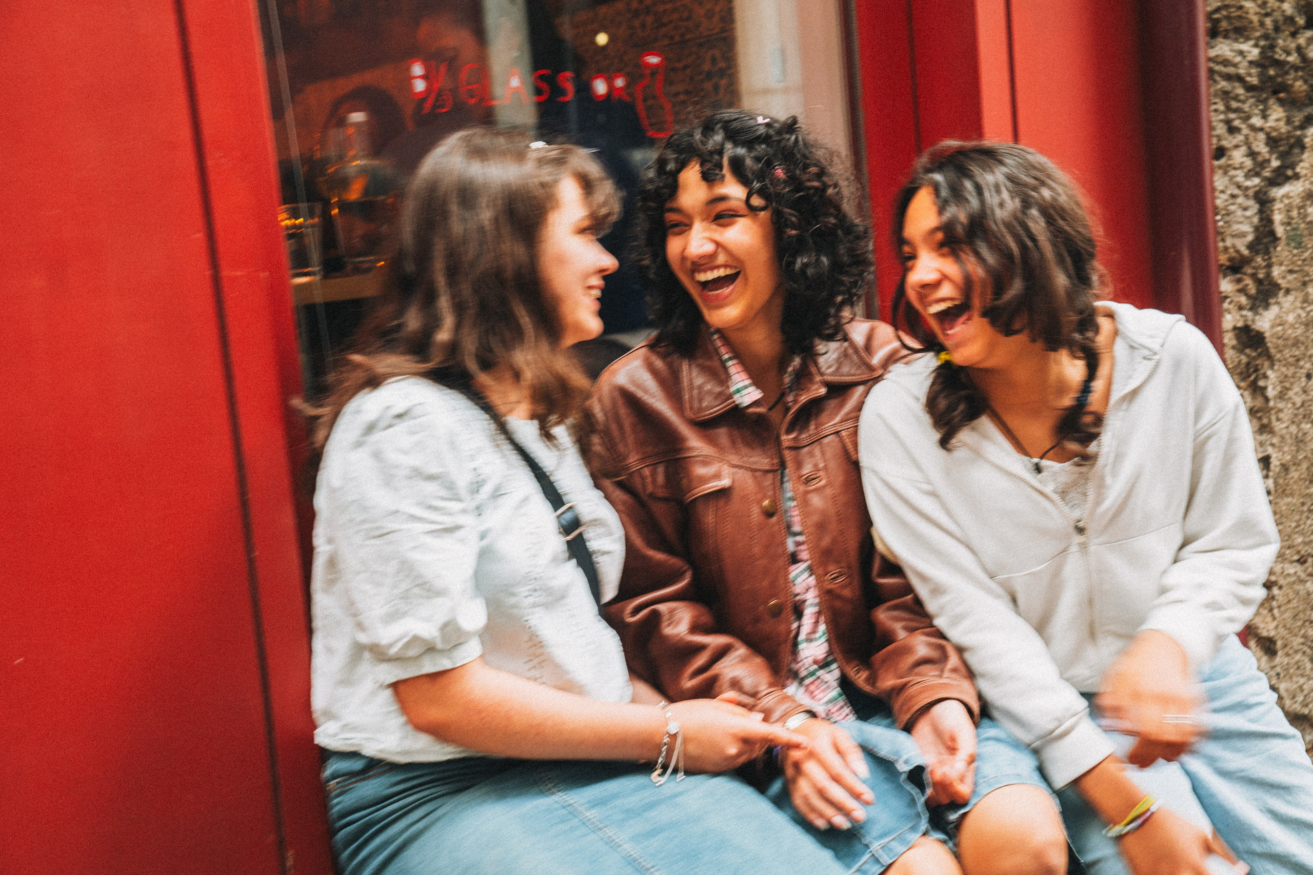 Группа людей семья влюбленные гуляет по живописной узкой улочке в Португалии, окружённой старыми домами и зеленью.