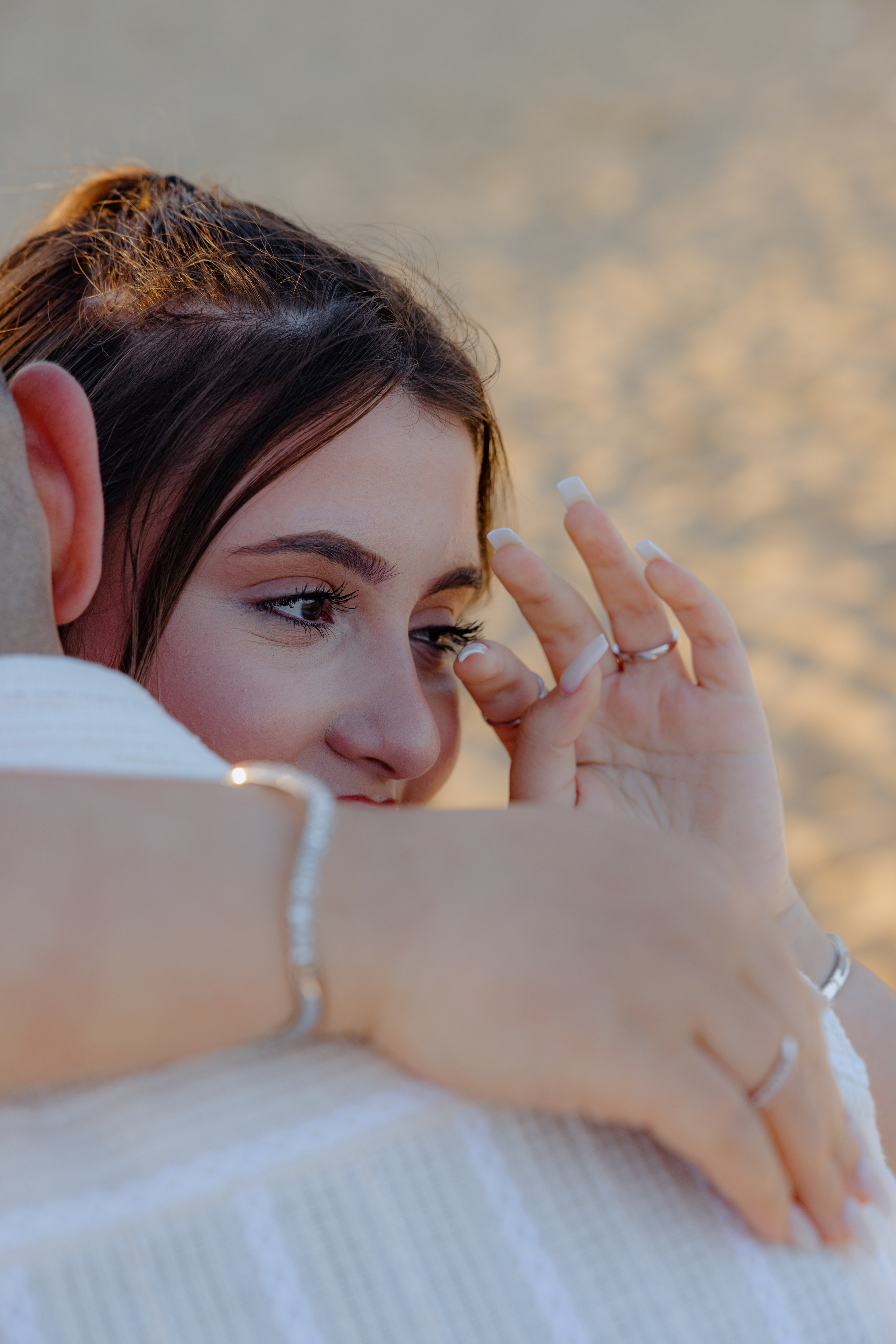 Just engaged couple laughing and holding hands after the proposal.