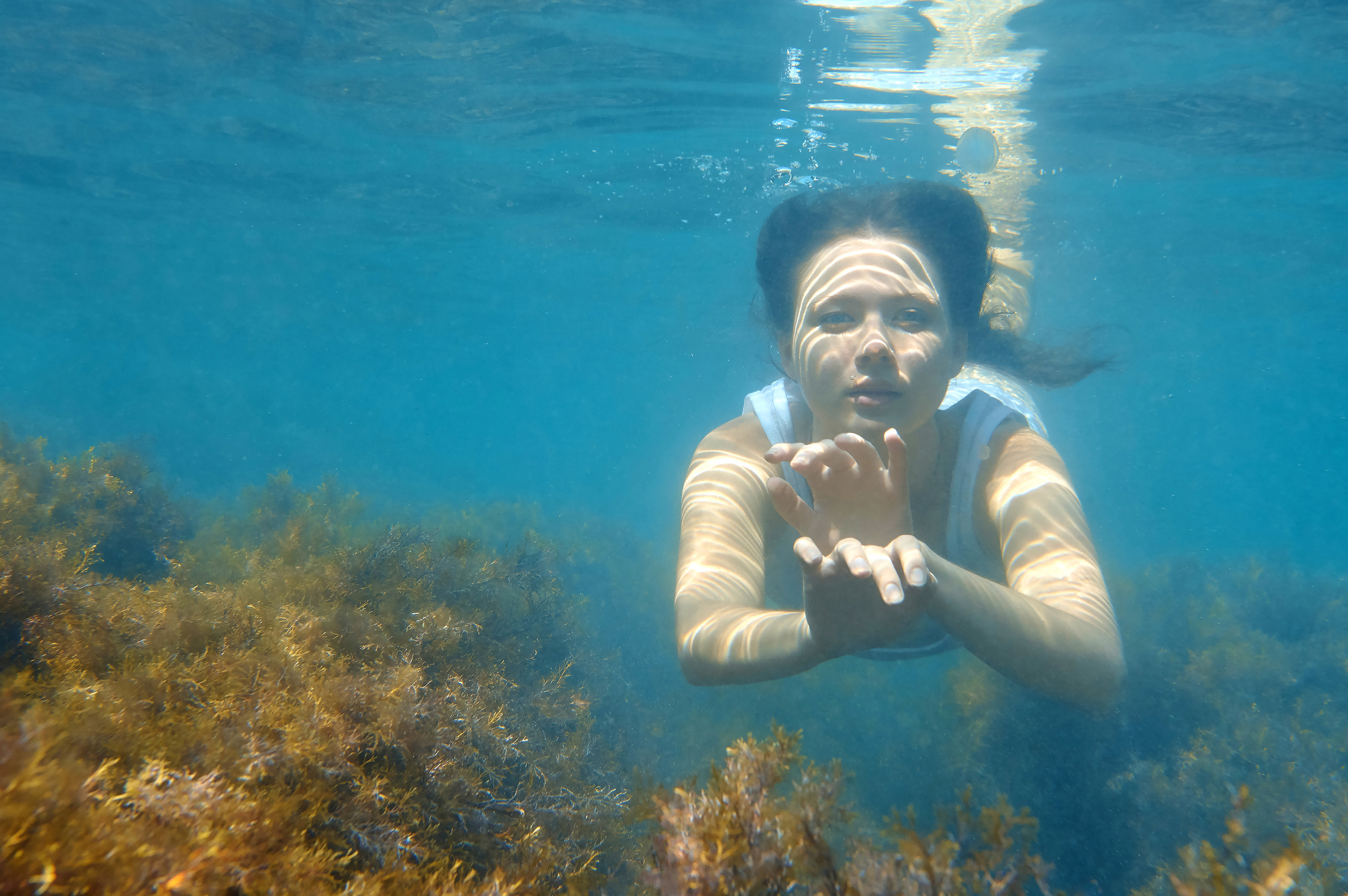 Девушка плывет под водой