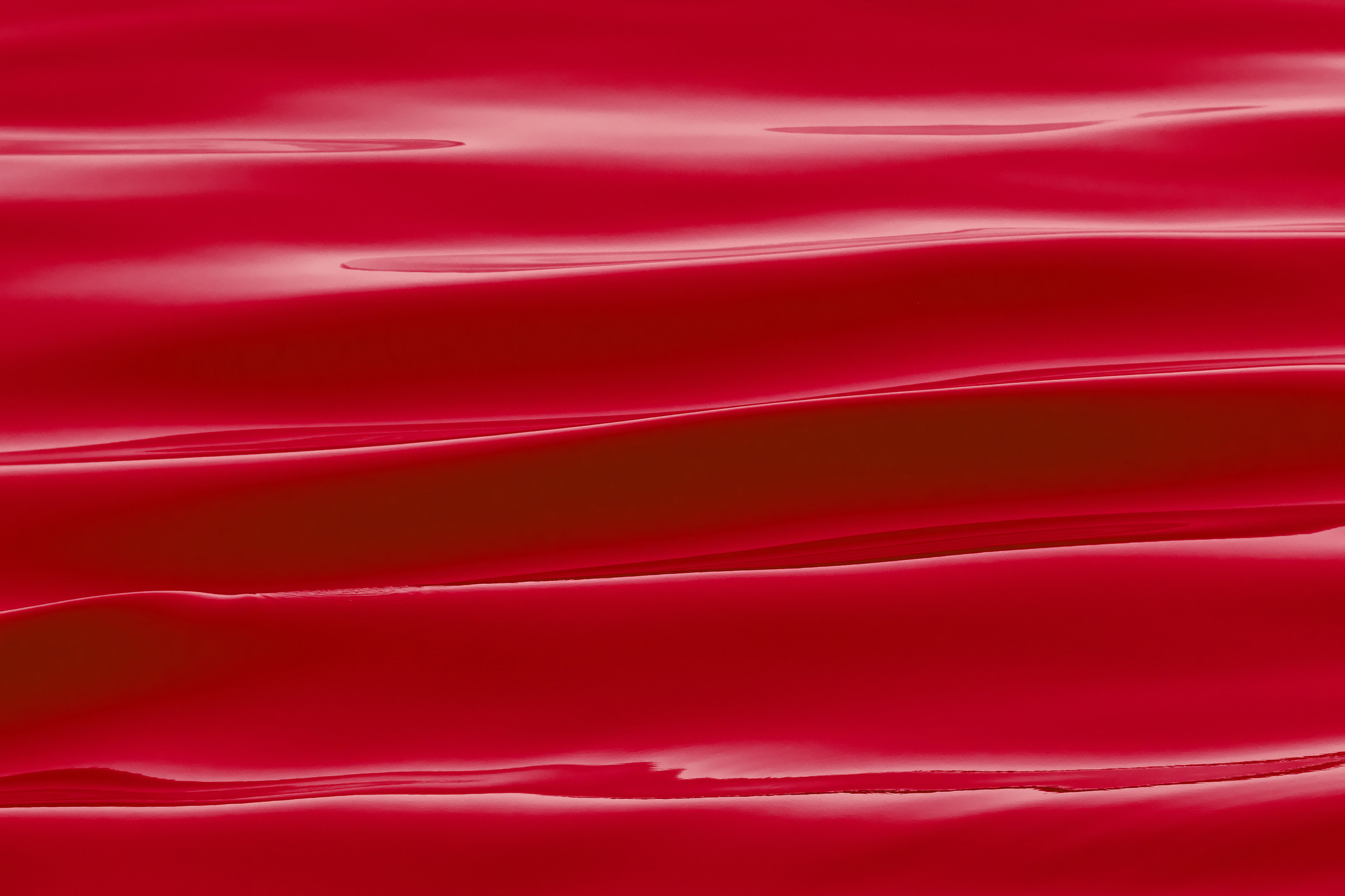 Маленькие гладкие красные волны на поверхности моря