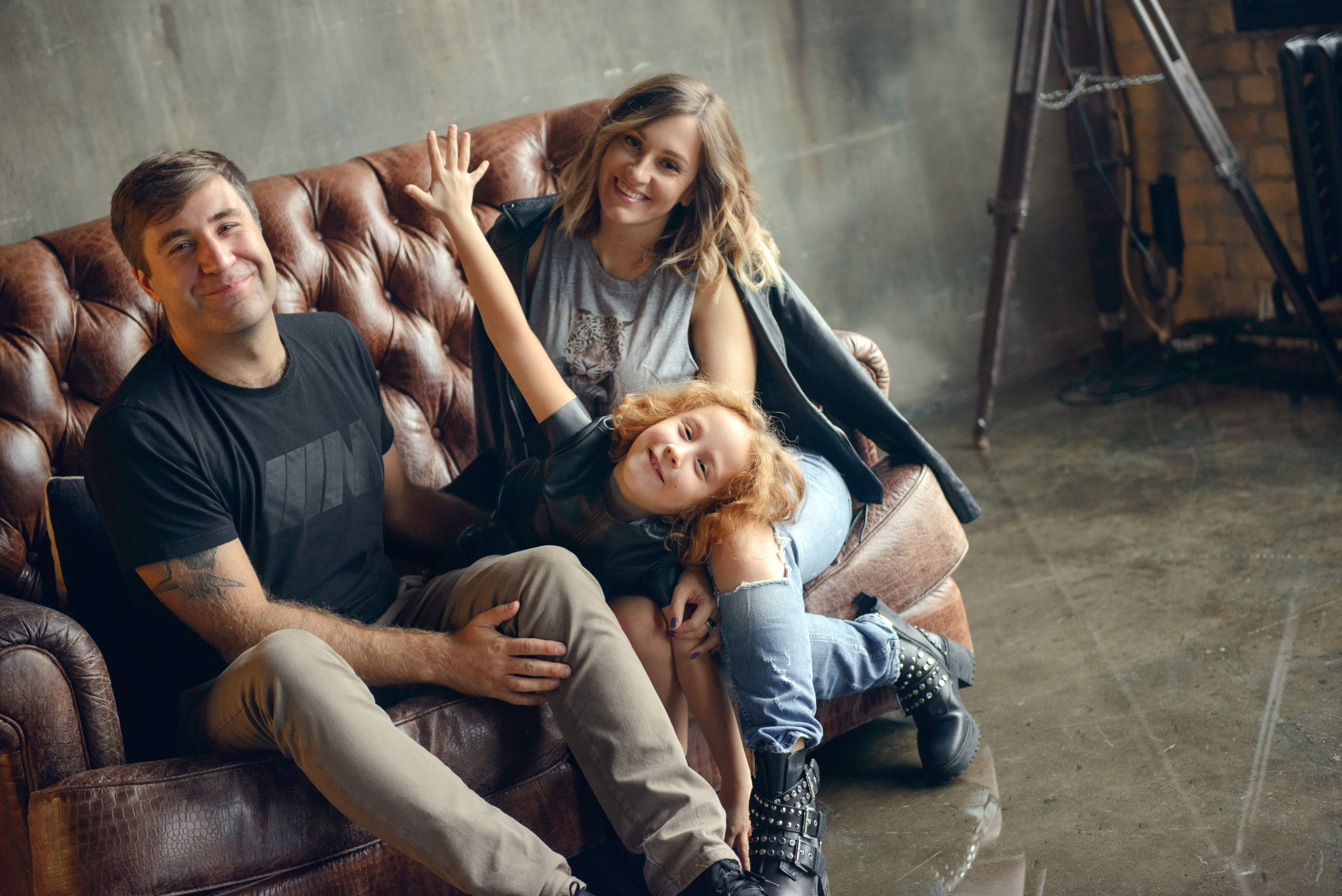 dad and daughter in a dark photo studio