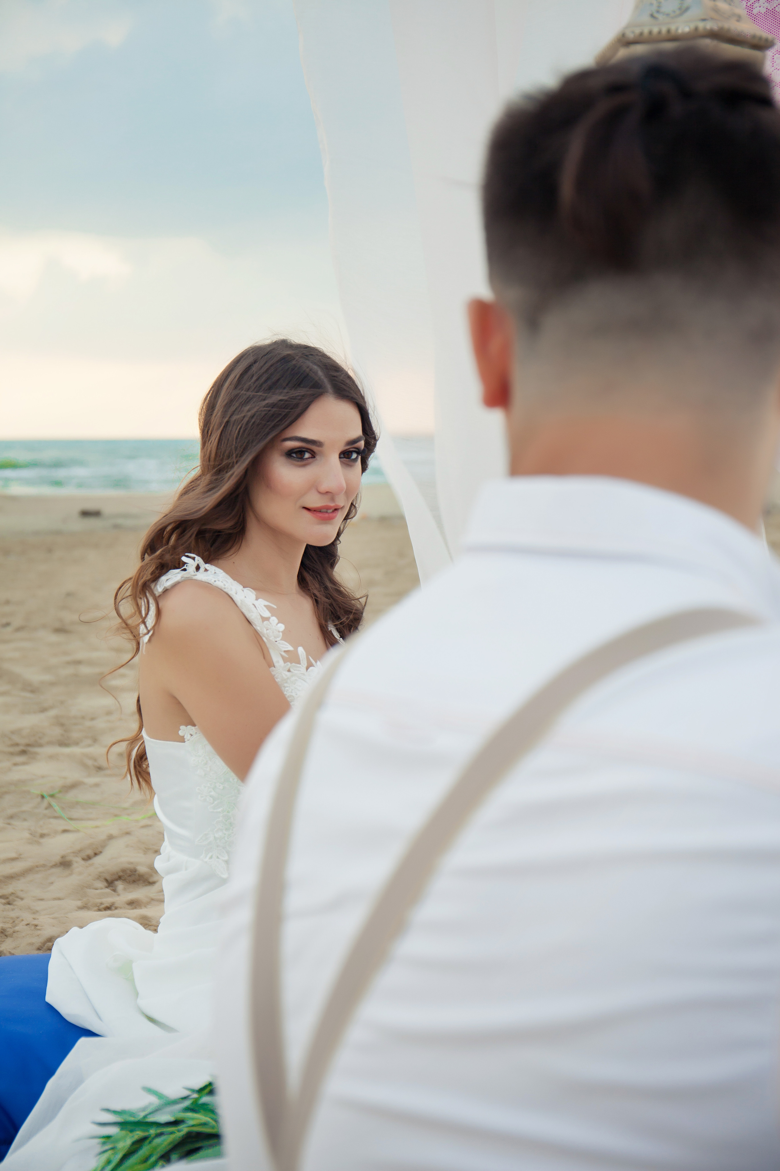 девушка сидит на песке и смотрит на меня