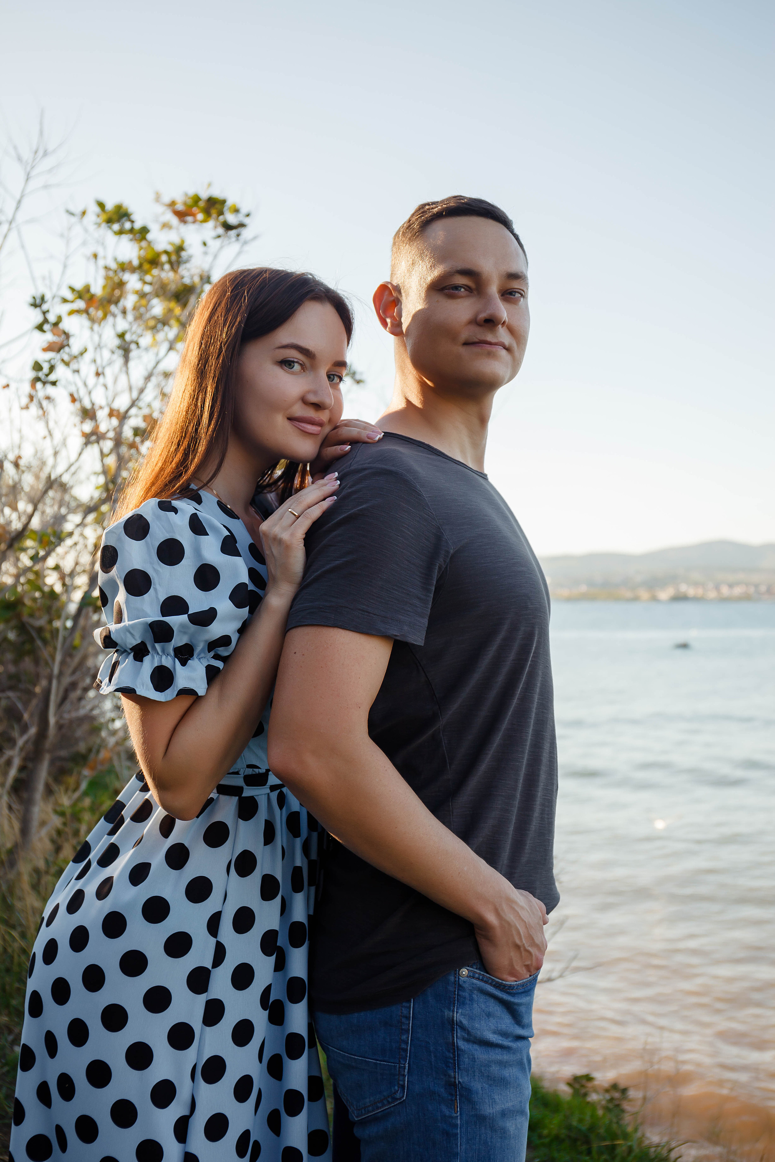 пара влюбленных обнимается на фоне черного моря