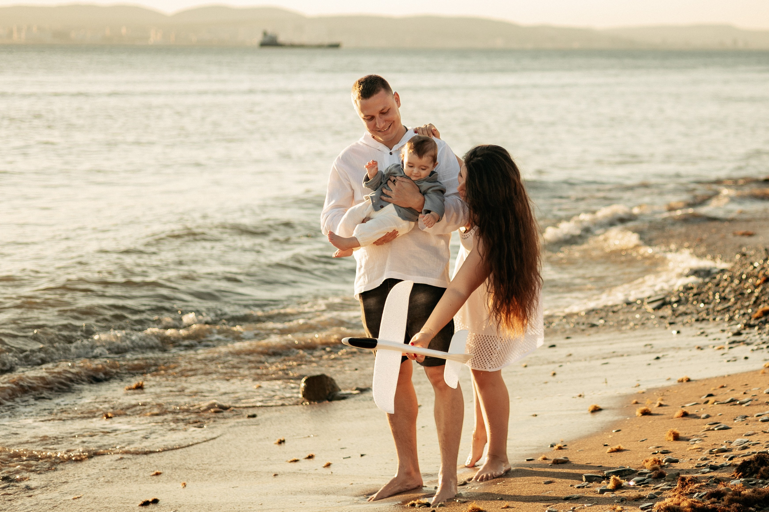 Естественный смех: мама и папа смотрят на летящий самолетик сына