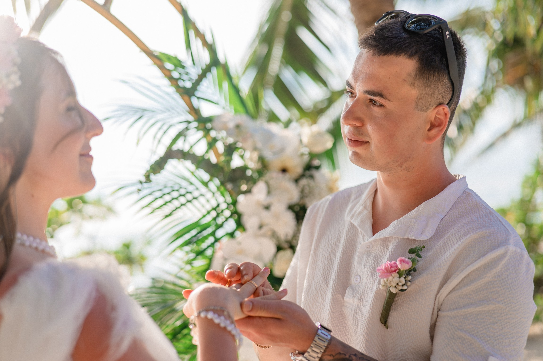Bride and groom exchanging vows on a private sunset beach