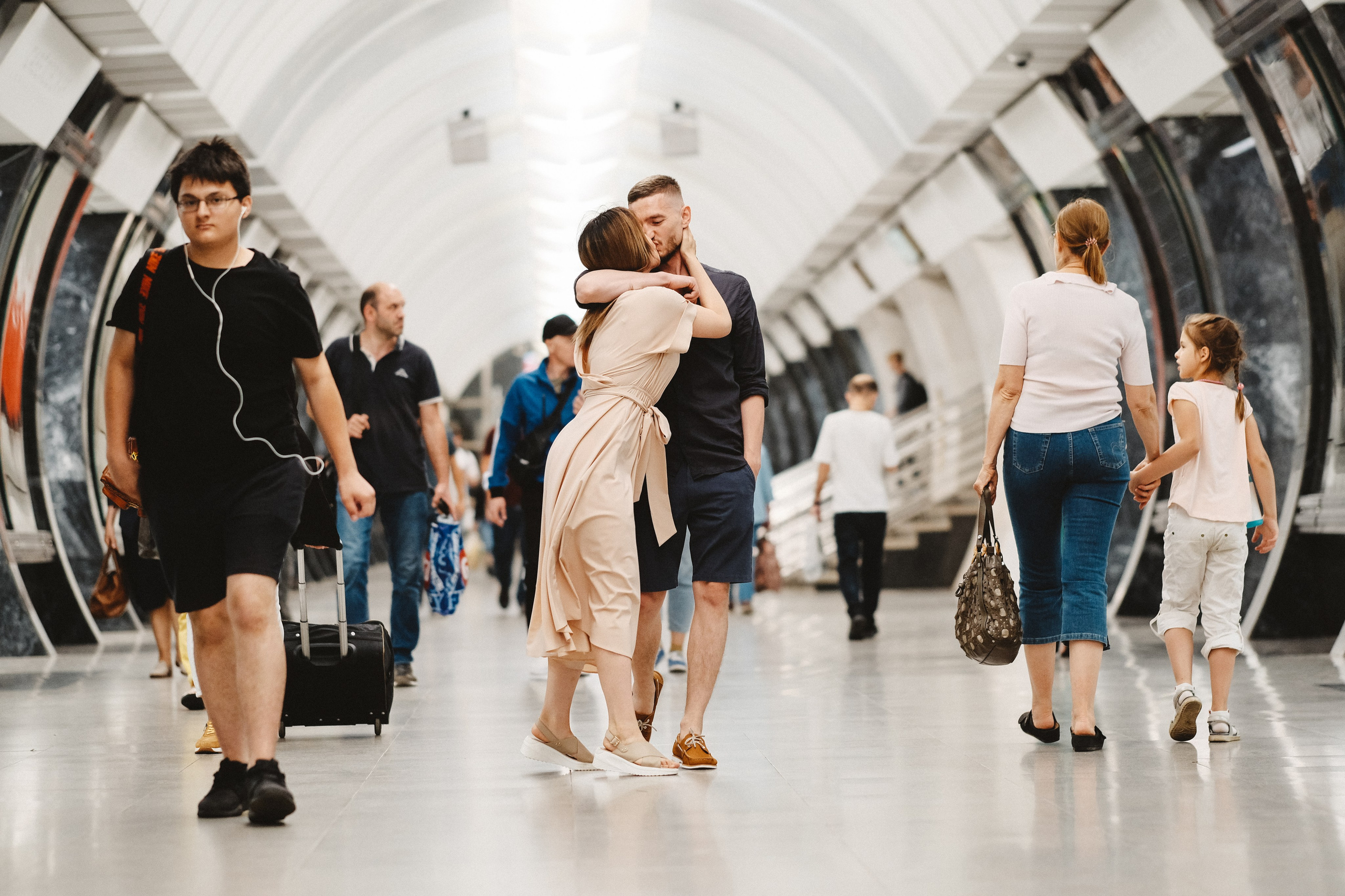 Поцелуй в метро среди толпы людей.