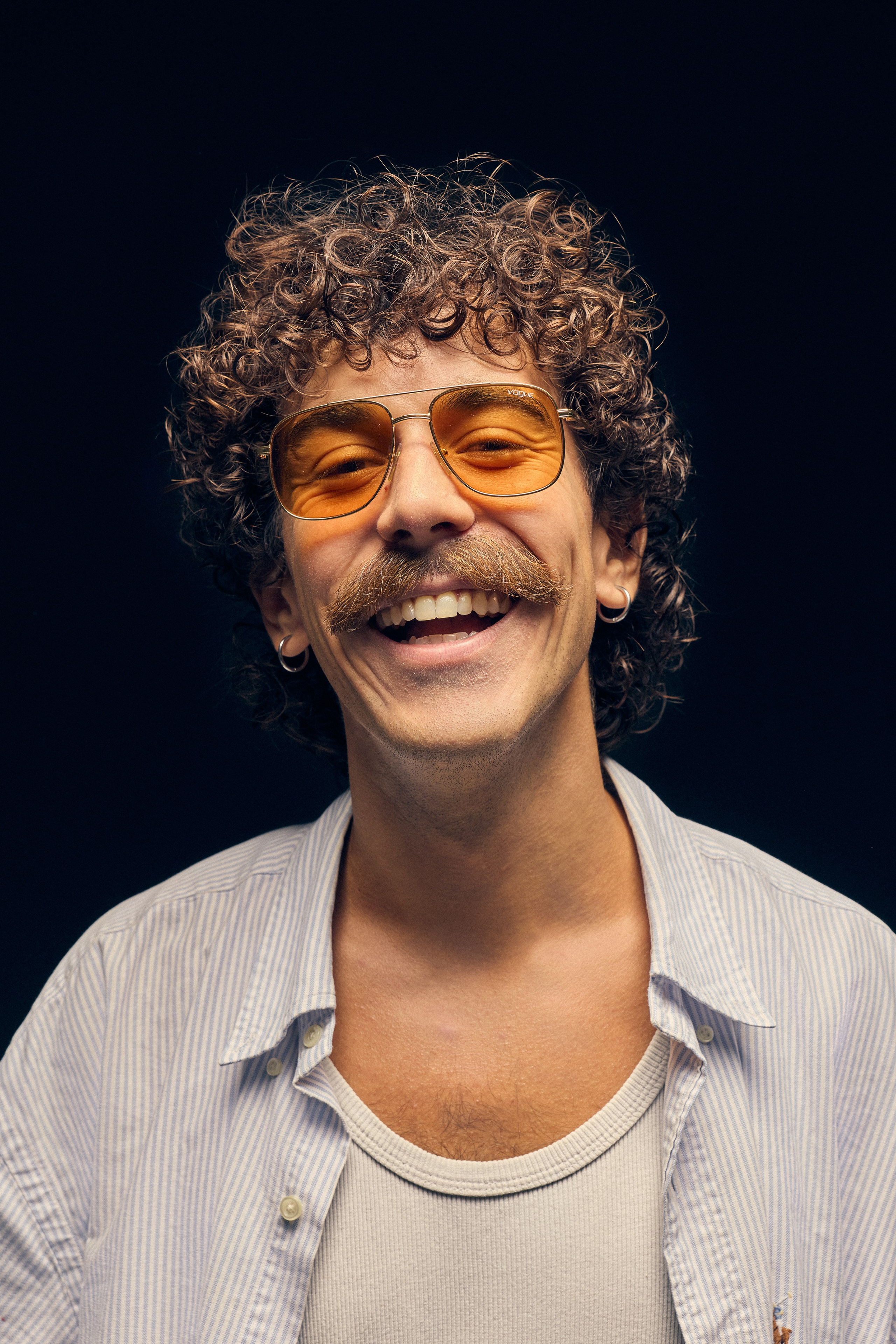 Artistic photography of man in open shirt with flour bag and liquor bottle