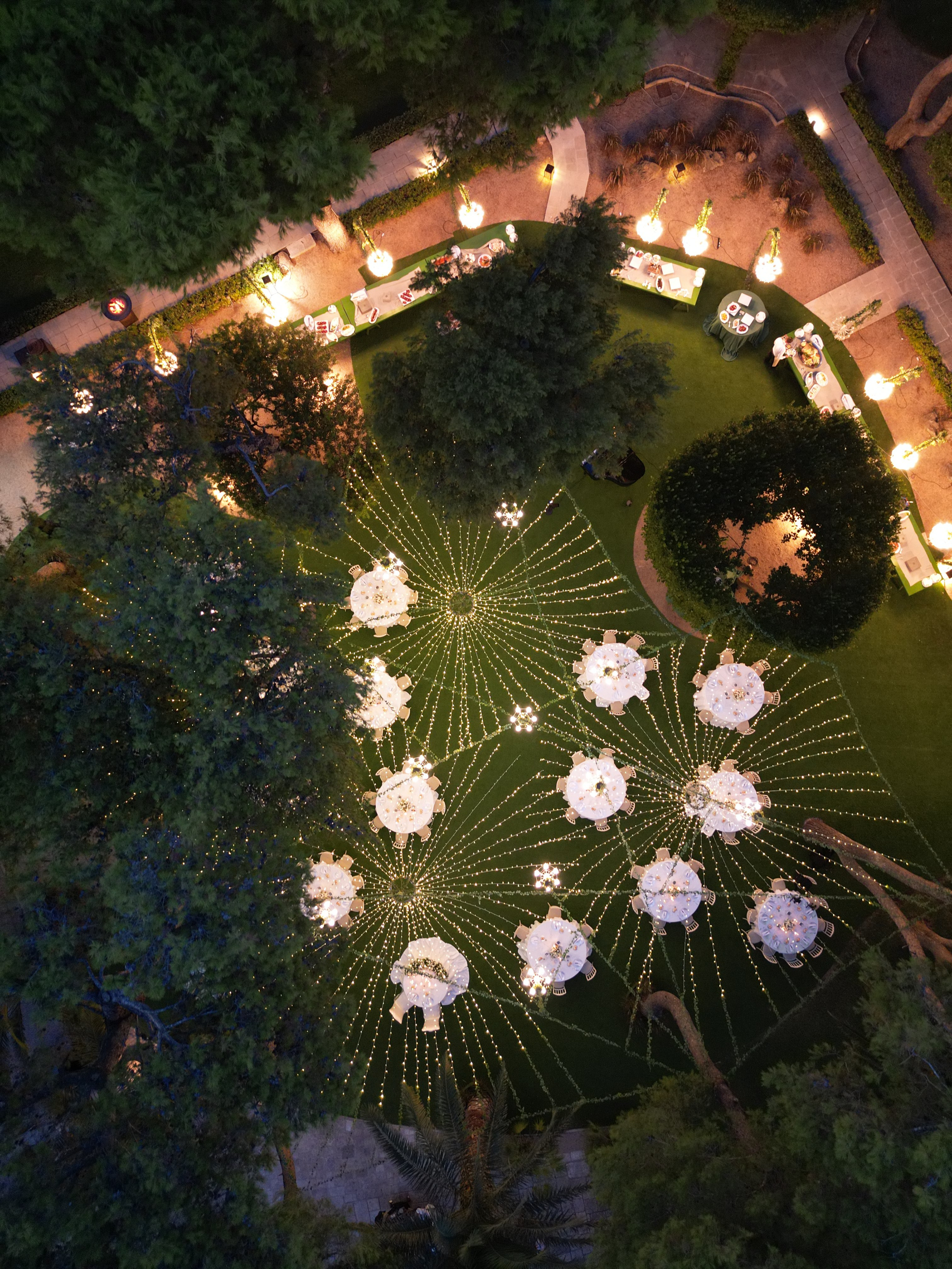 Outdoor wedding reception decorated with lights in an Italian garden