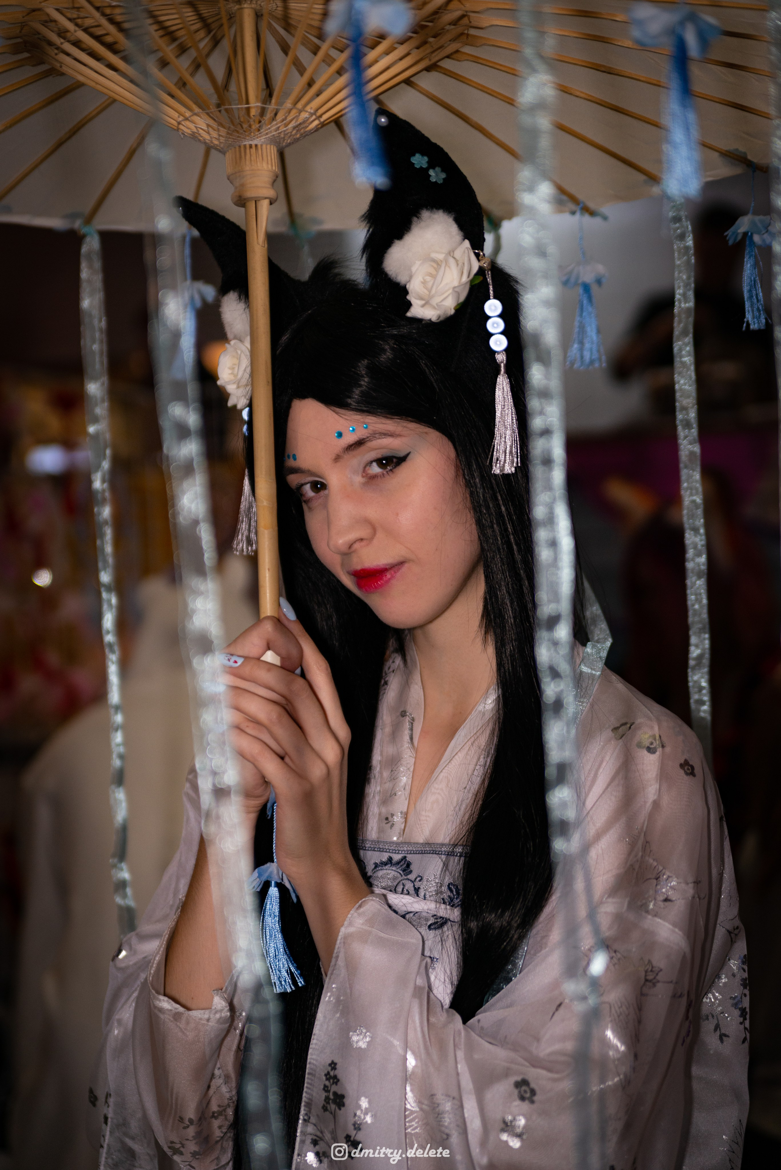 девушка в китайском национальном платье с зонтиком портрет через свисающие с зонта ленты