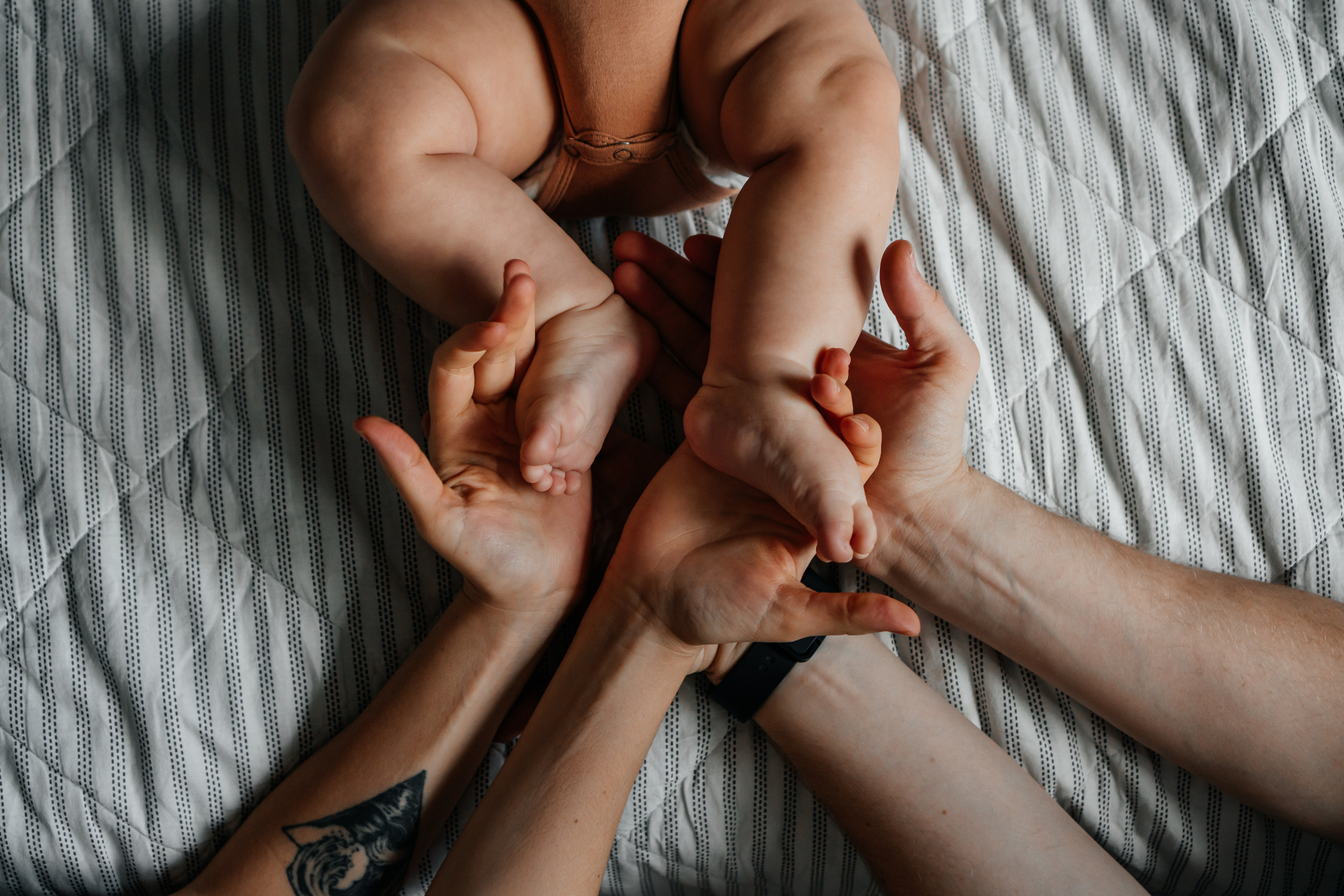 маленькие ножки ребенка в руках взрослых