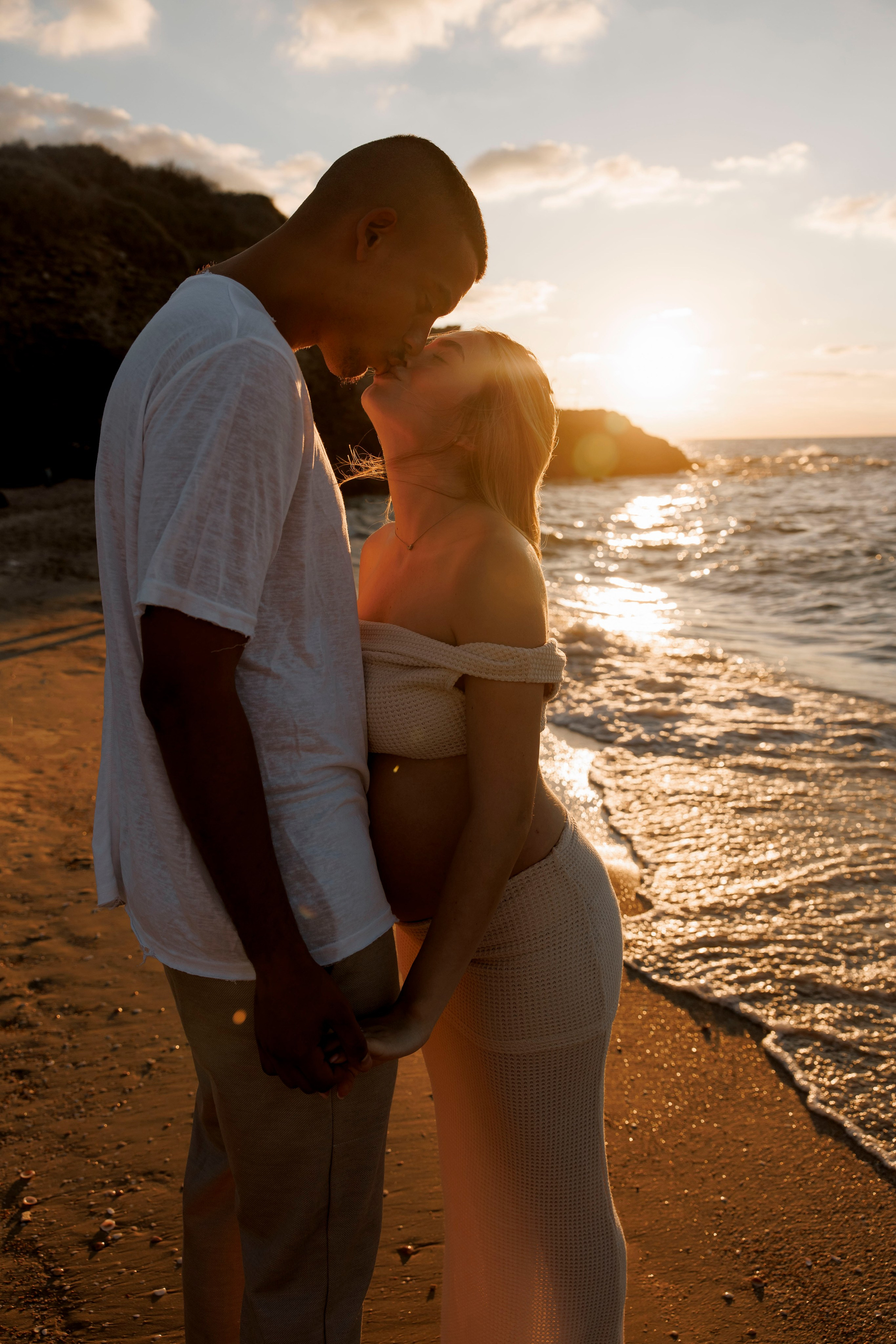 Pregnancy photoshoot near the sea. Wedding and family photographer