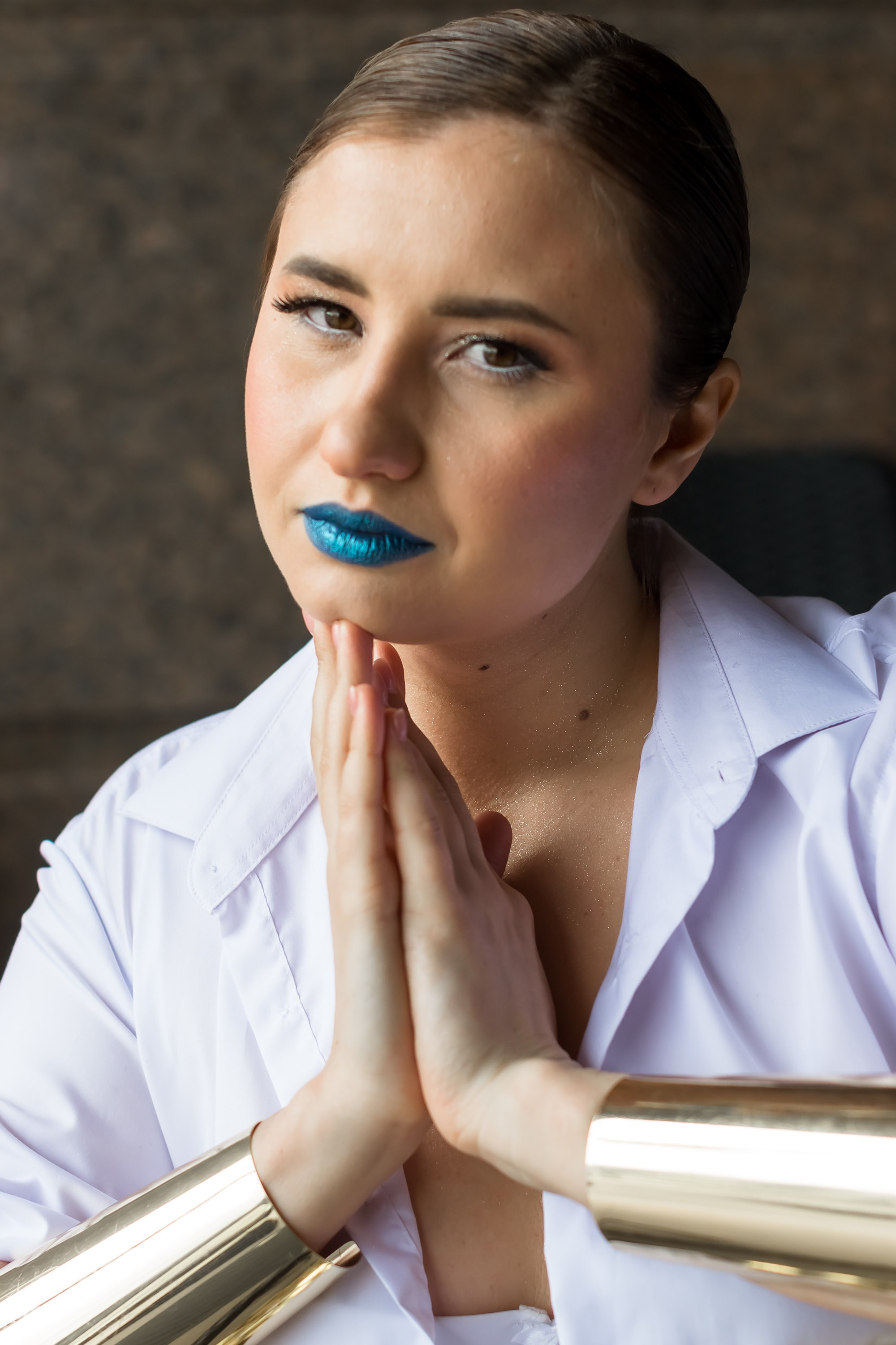 На фото девушка в белой рубашке яркий макияж.