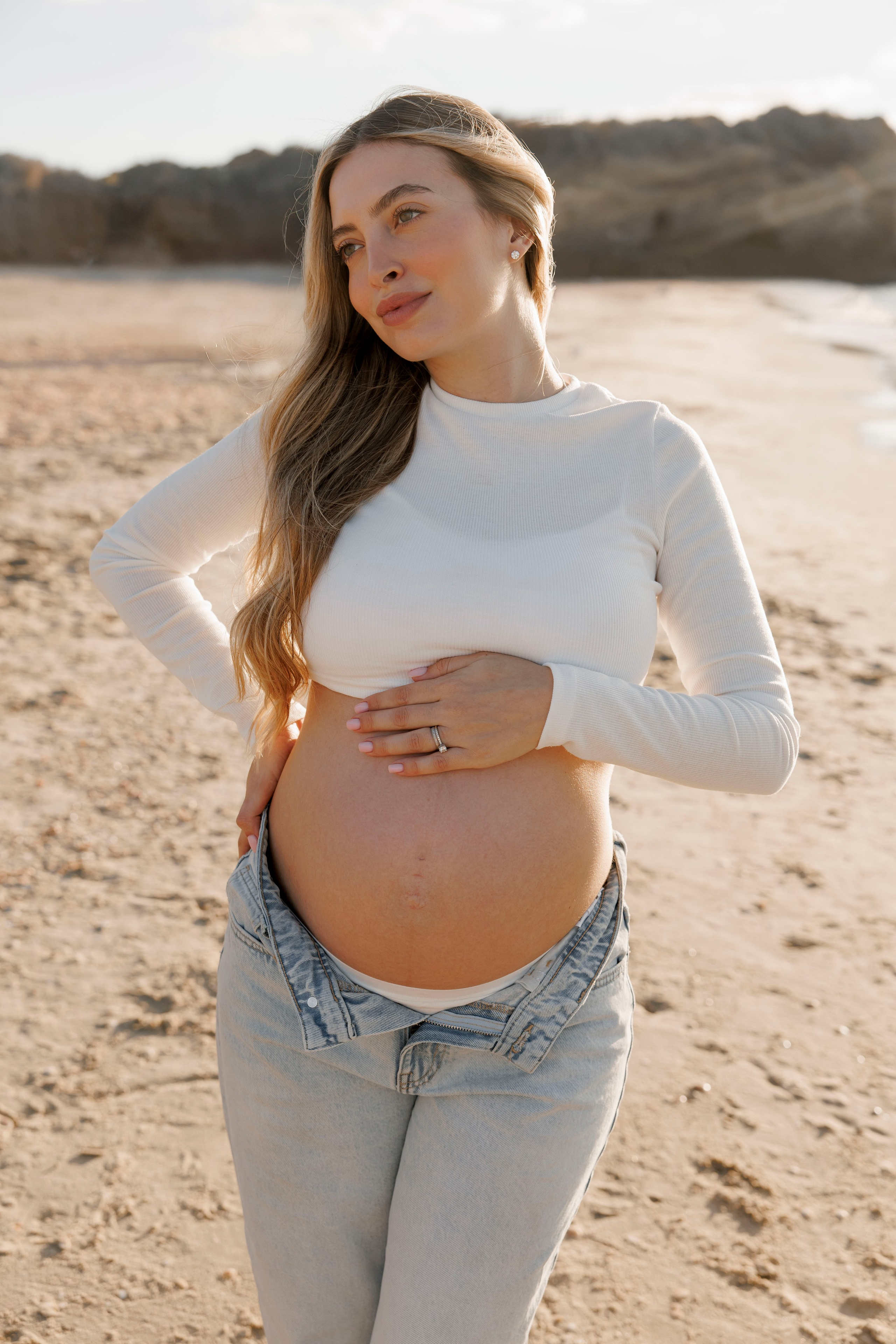 Pregnancy photoshoot near the sea. Wedding and family photographer
