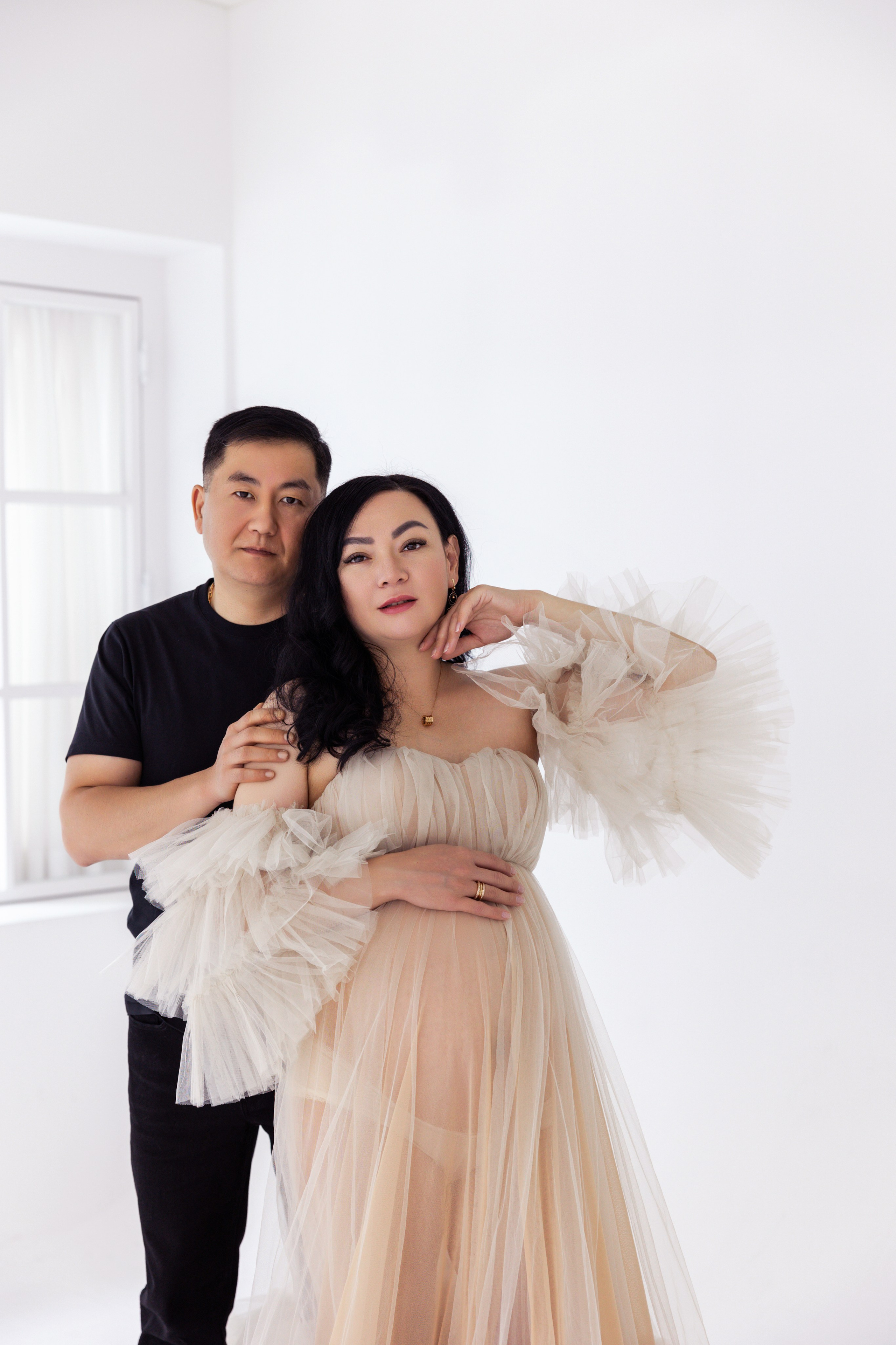 Pregnancy photo session with husband in studio