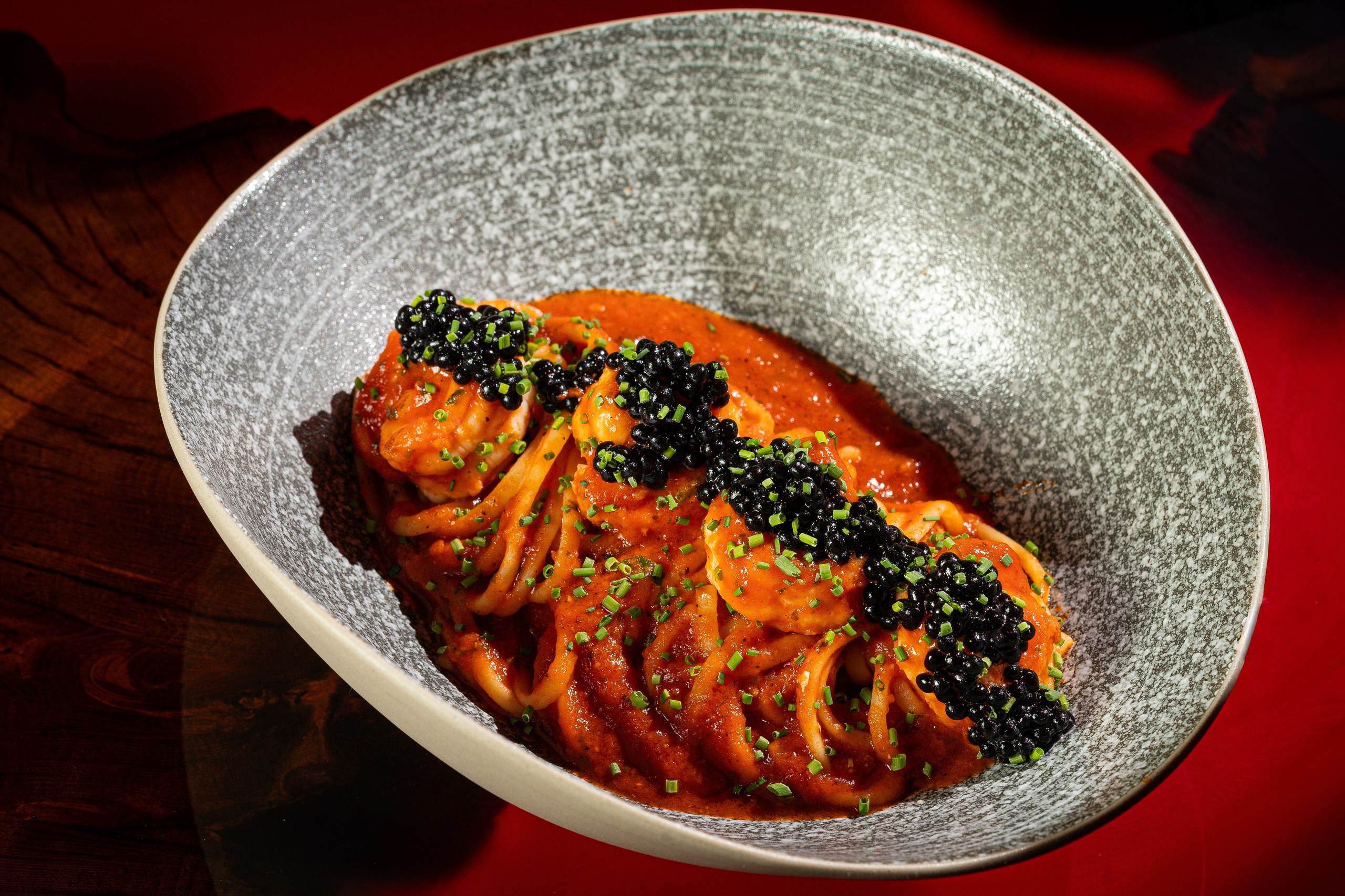 Паста в томатном соусе. Украшена чёрной икрой