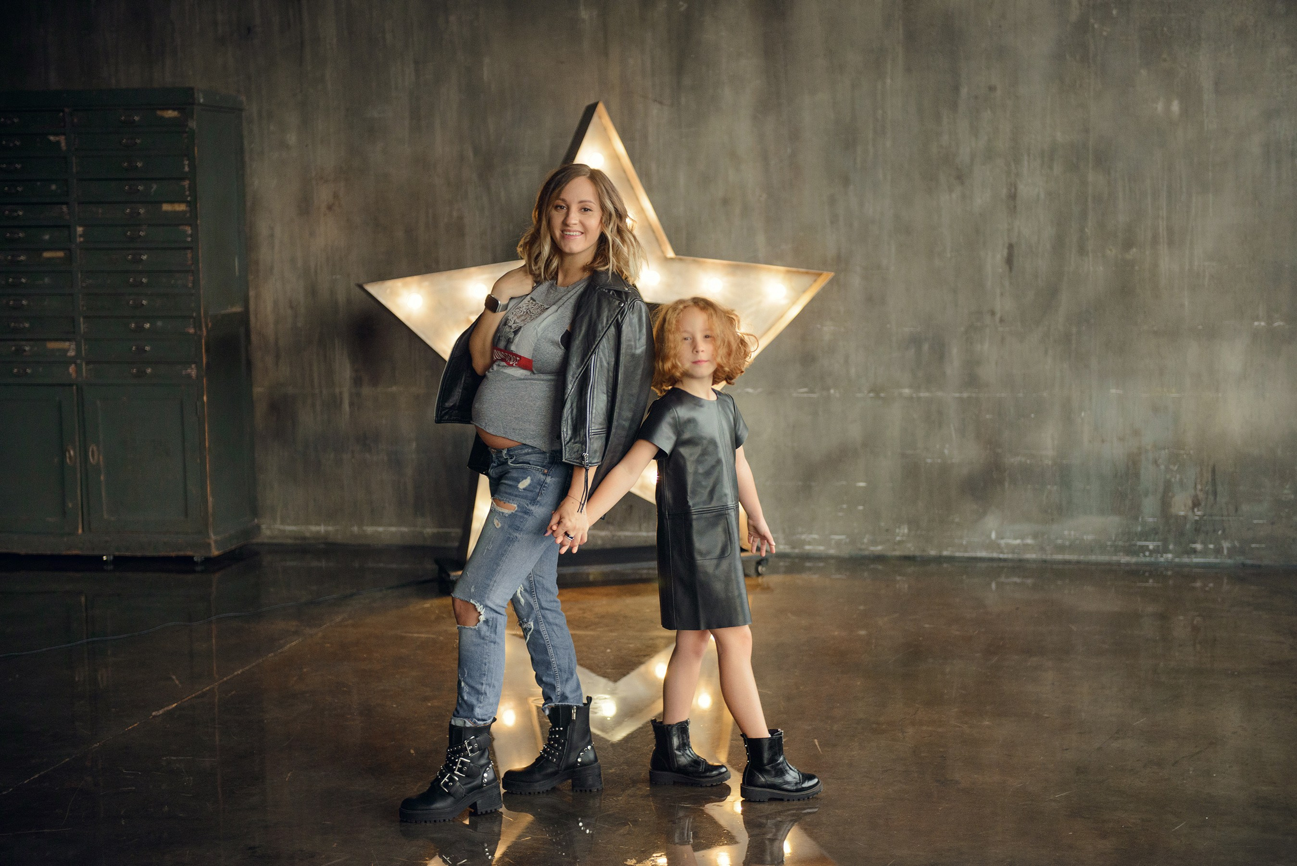 Family photo shoot with a pregnant woman in a loft studio, rock and roll style