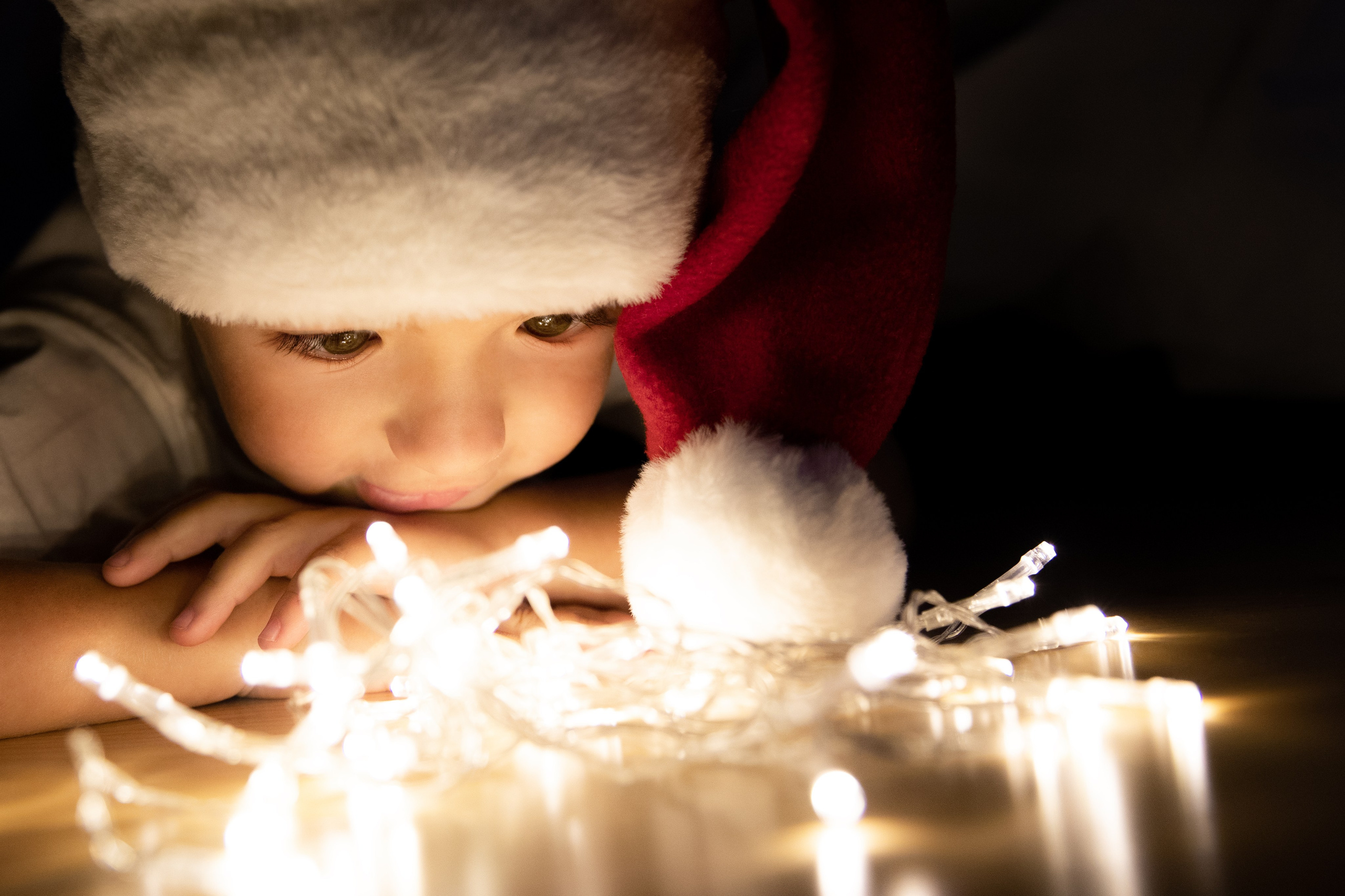 A brother and sister with lights and candles play on Christmas night and celebrate New Year's Eve