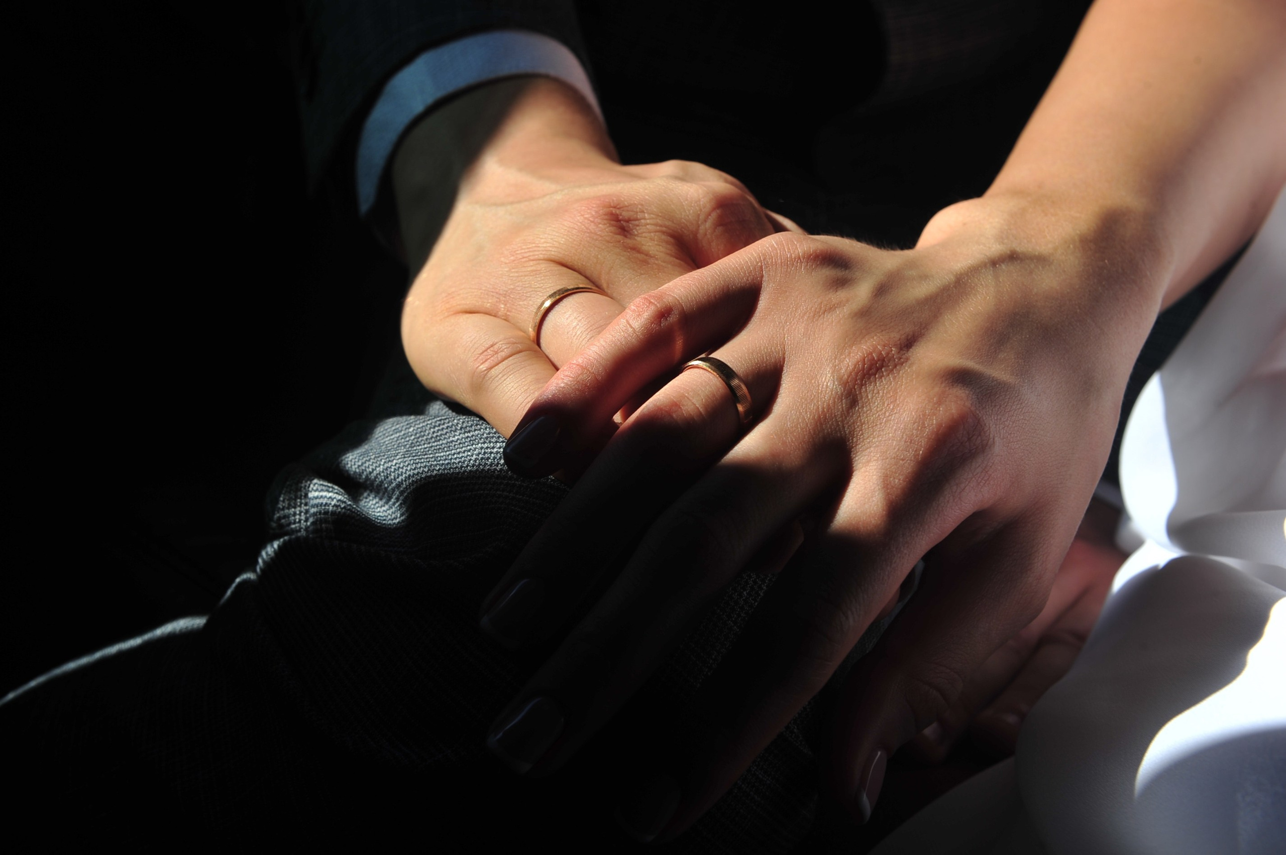 Свадьба на Воробьёвых Горах рядом с МГУ, руки новобрачных с обручальными кольцами в солнечном луче на закате