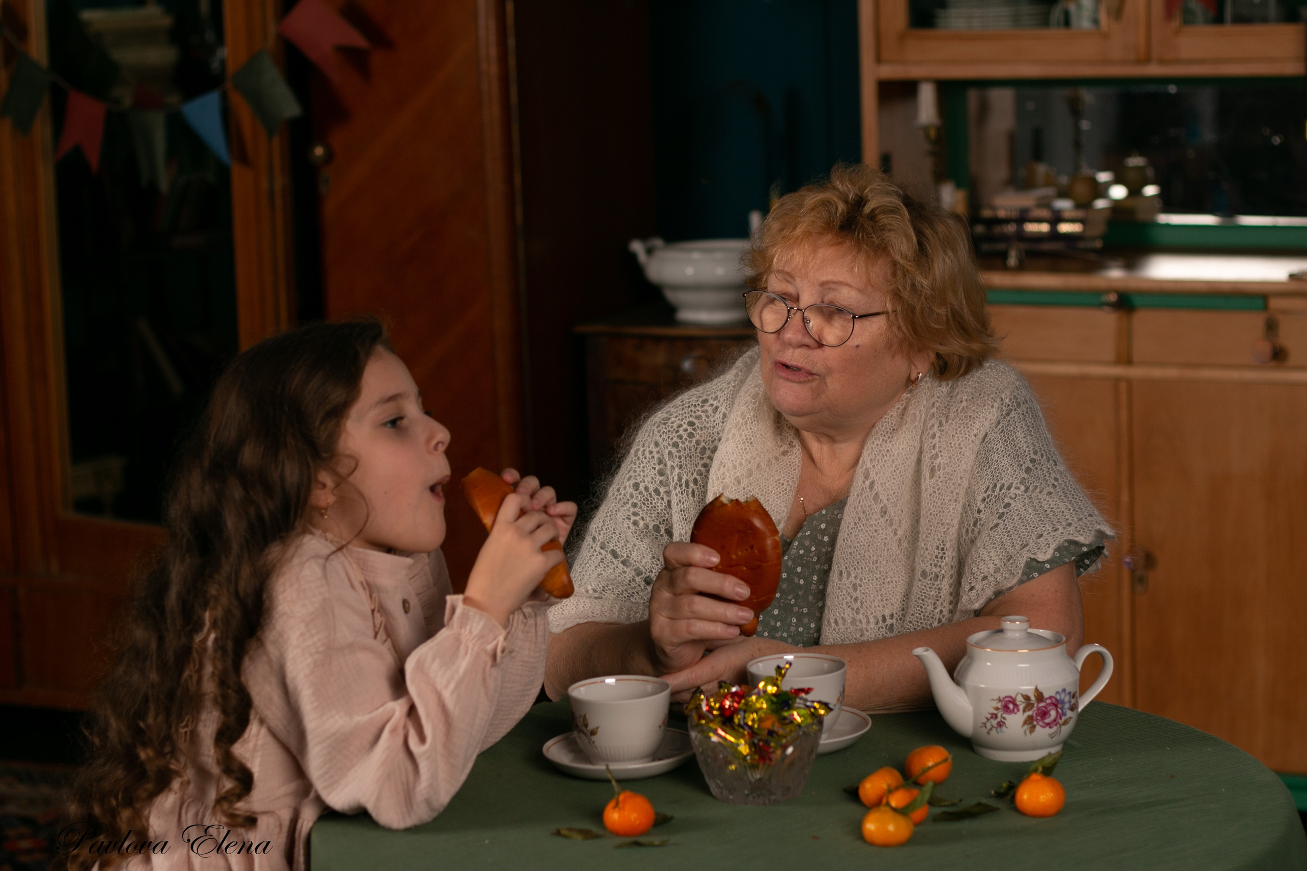 Душевный разговор: бабушка и внучка делятся секретами и опытом, теплый свет лампы, чашечка чая