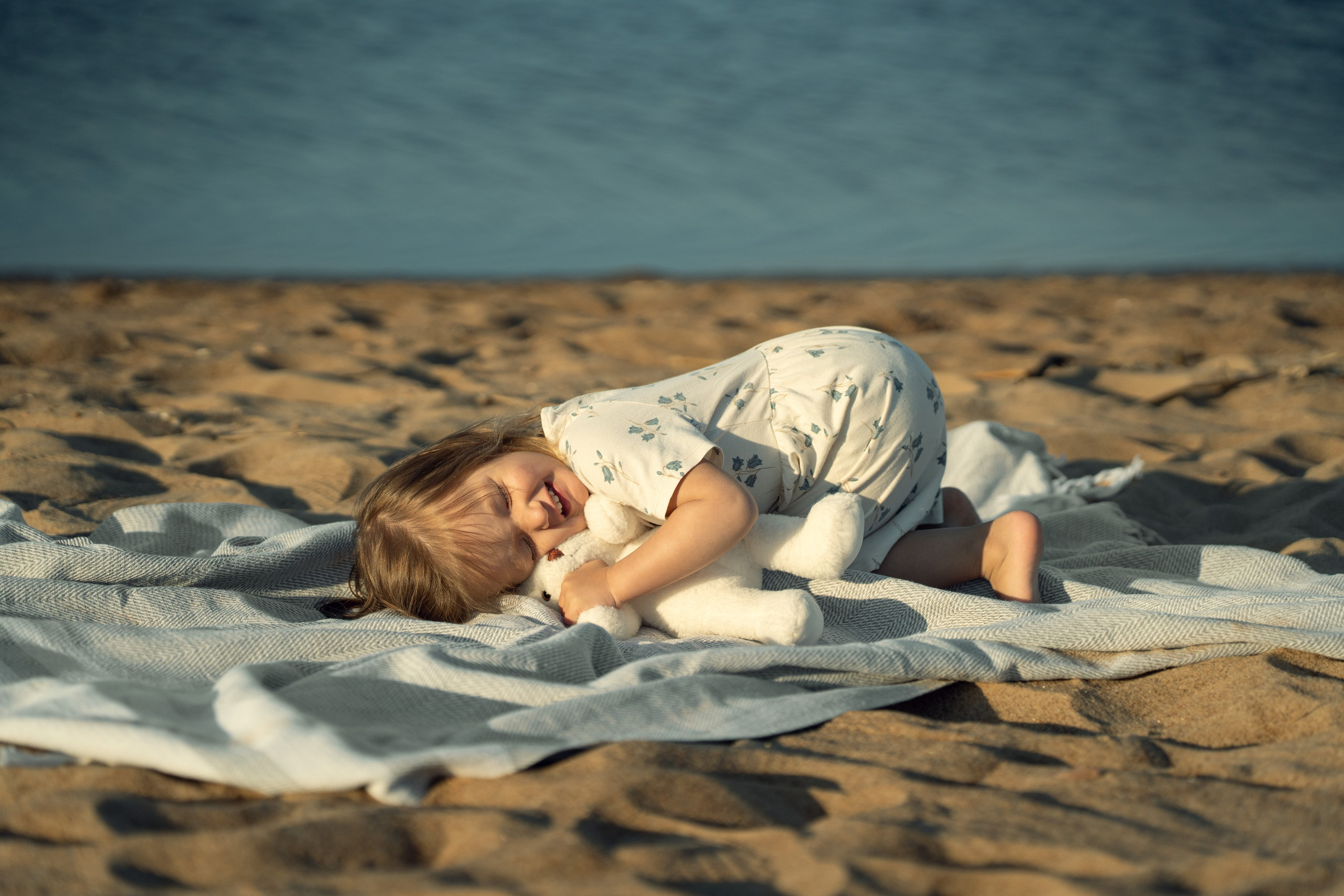 Детский портрет девочки, обнимающей своего любимого мишку.