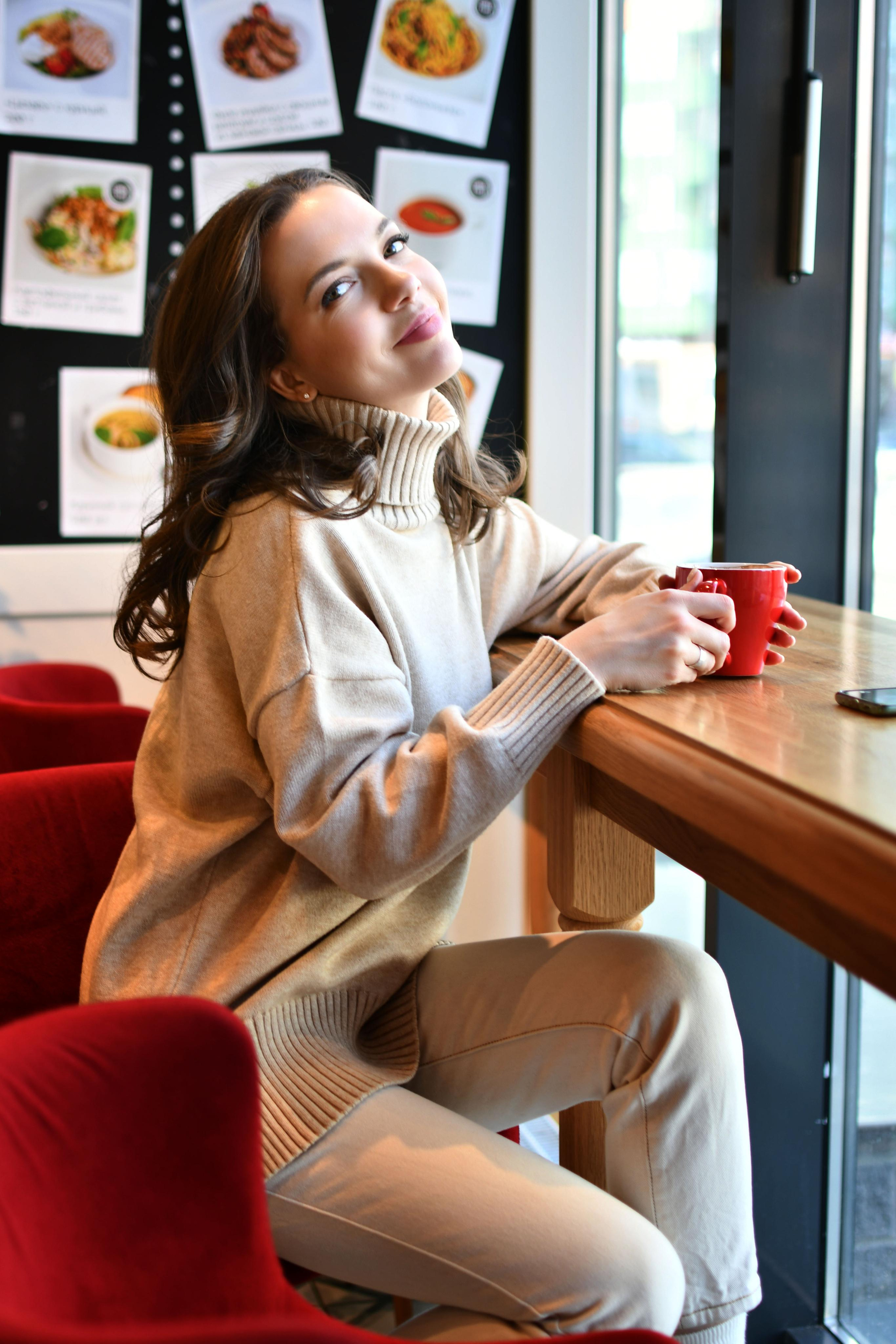 Красивая девушка в кафе за чашкой кофе в кафе Британские Пекарни Спб
